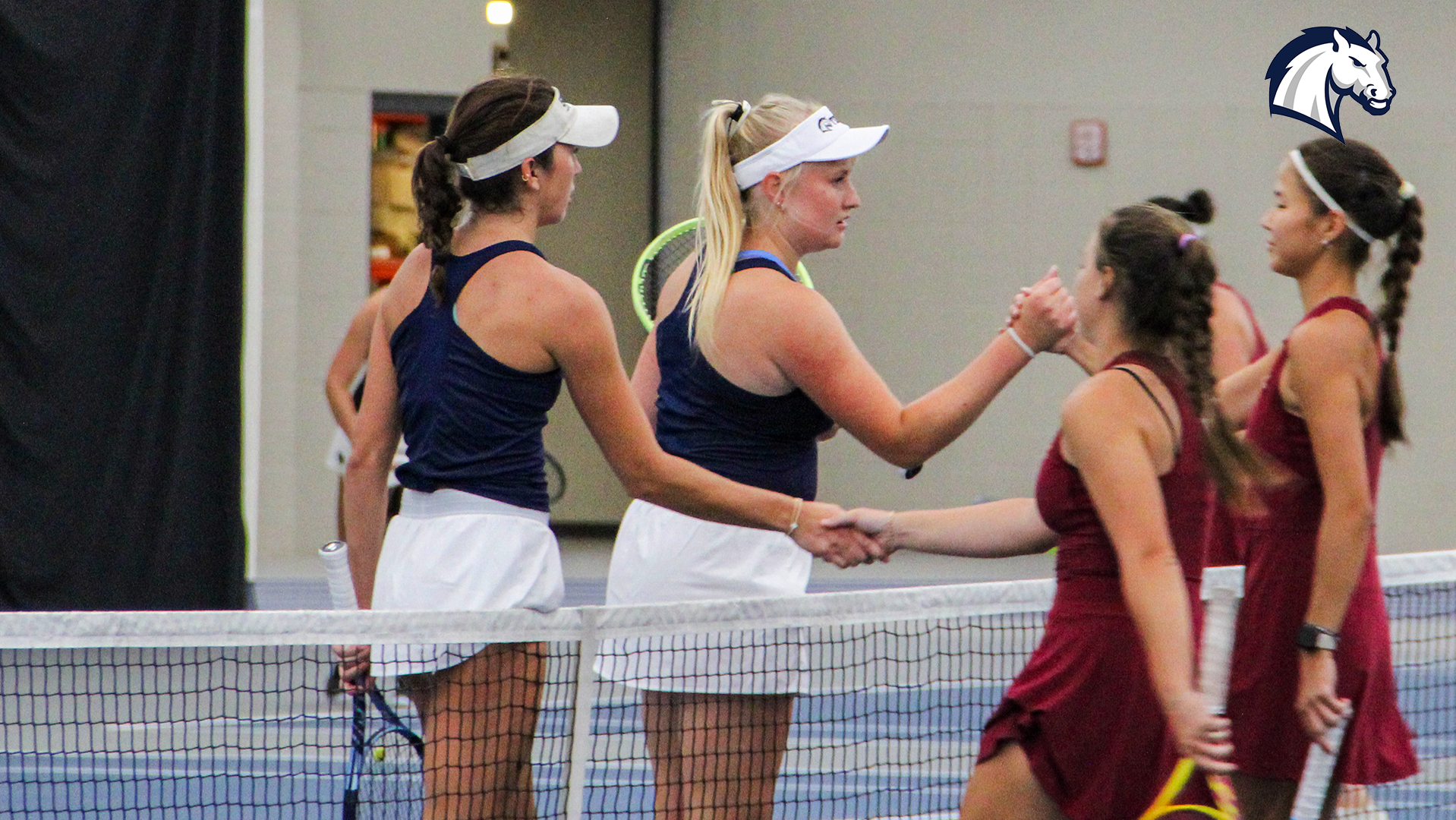 Hillsdale's Briana Rees and Ane Dannhauser (left) shake hands with a doubles opponent from Walsh after winning a match at the Chargers' Summer Invitational on Saturday, Sept. 19, 2026