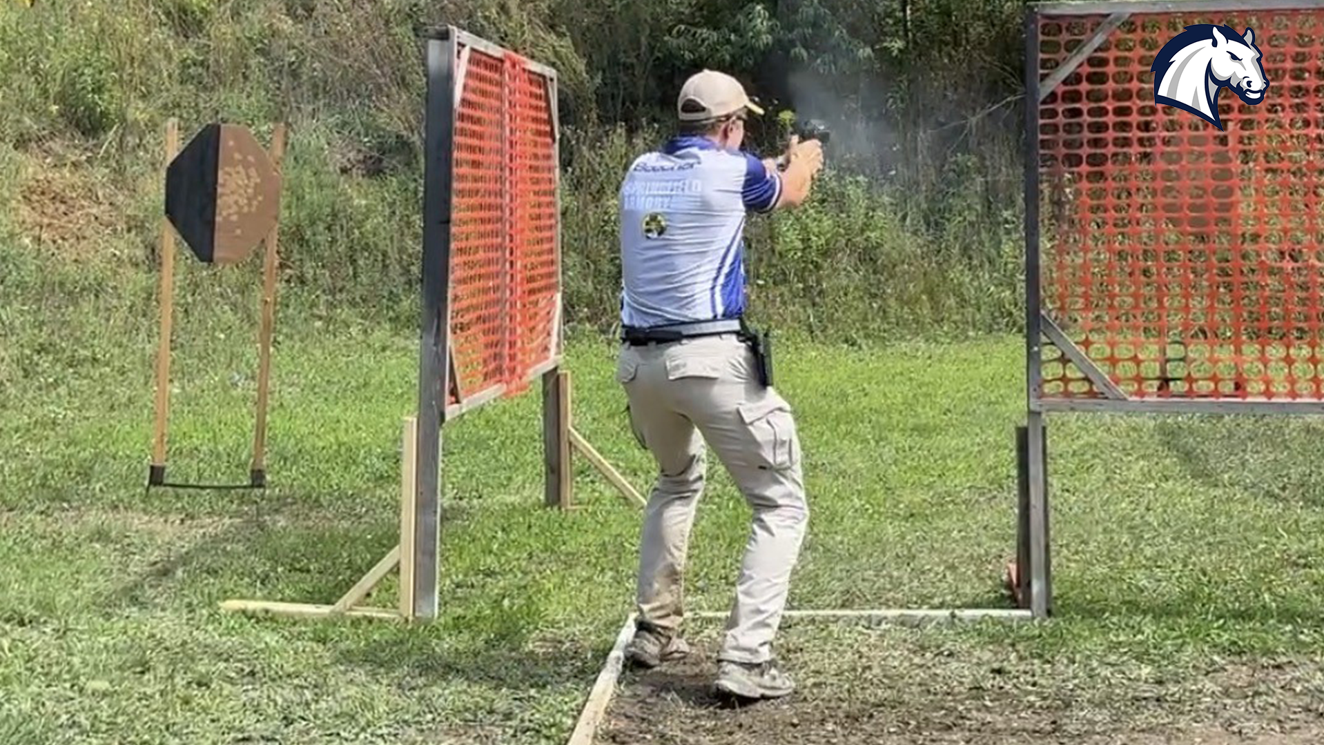 A Hillsdale action shooting team member competes on a stage during a match in August 2026.