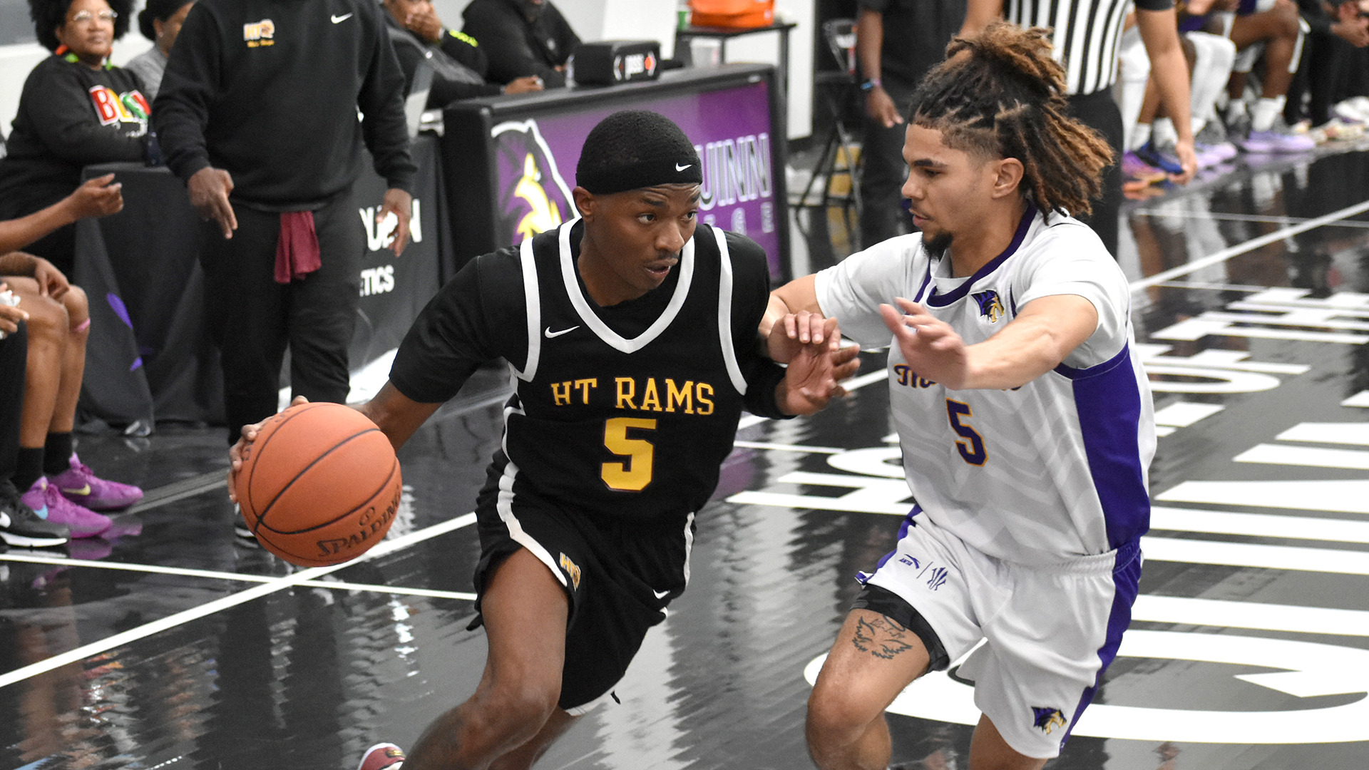 HT's Ja'Patrick Blackmon (with ball) dribbles past Paul Quinn College's Jordan Hicks in a game at PQC on Saturday, Dec. 13