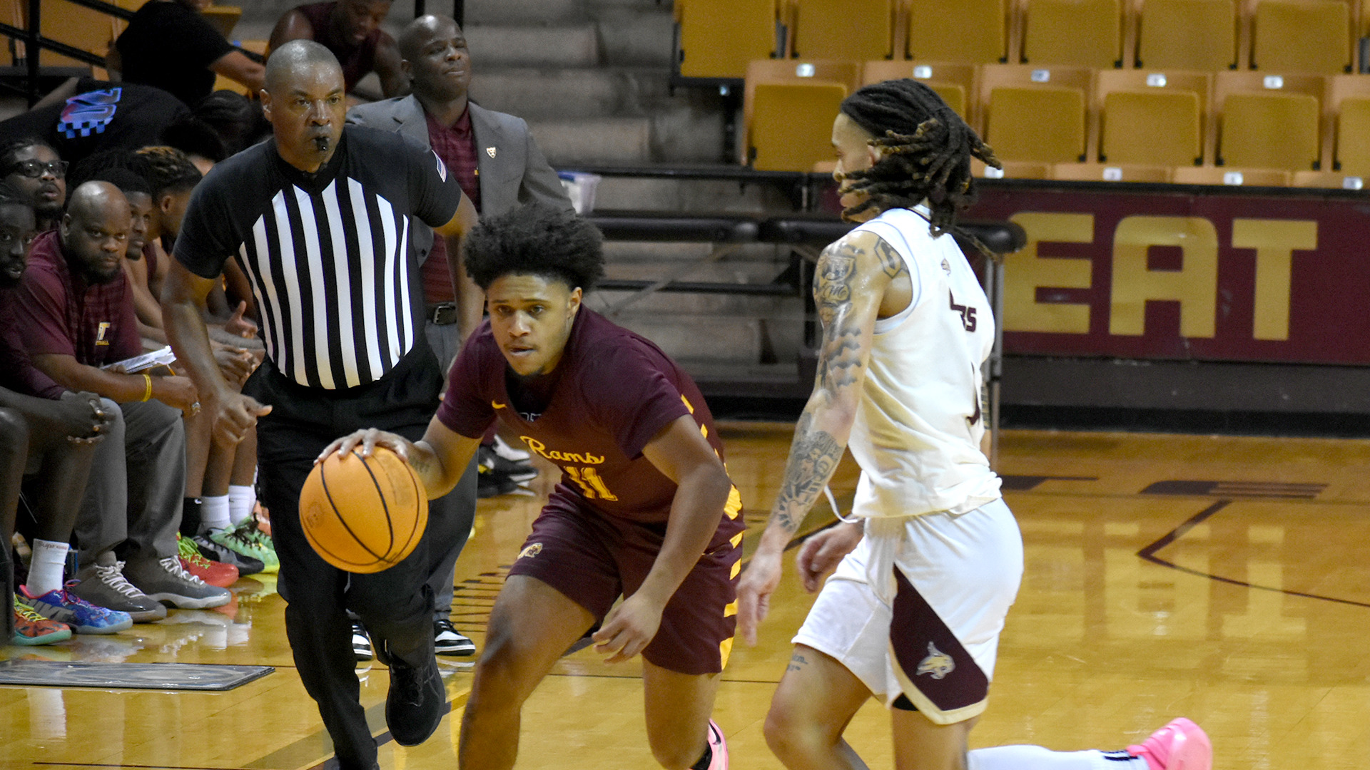 Isaiah Halliburton (left, with ball) dribbles around a Texas State defender in an exhibition game earlier this season