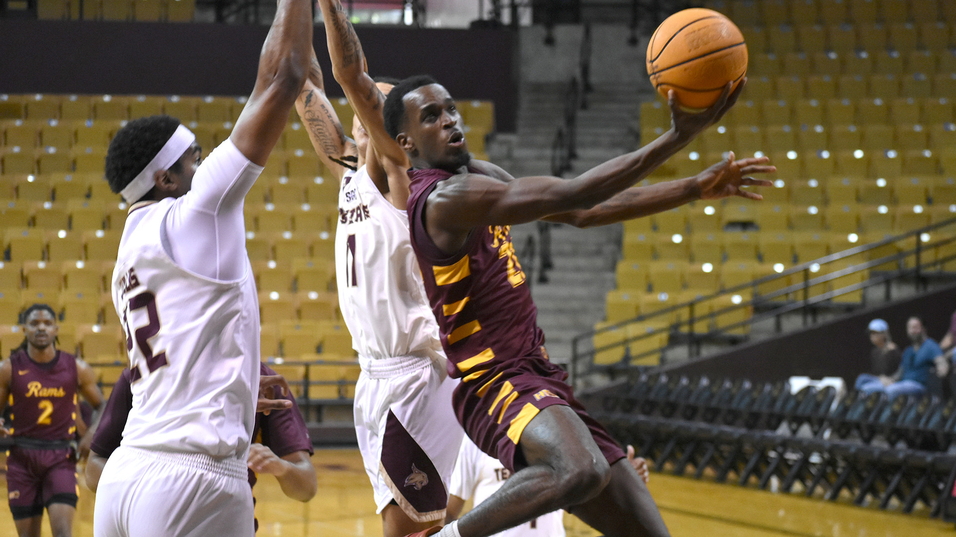 Shannon Robinson goes in for a layup past two Texas State defenders in an exhibition game earlier in the 2025-26 season