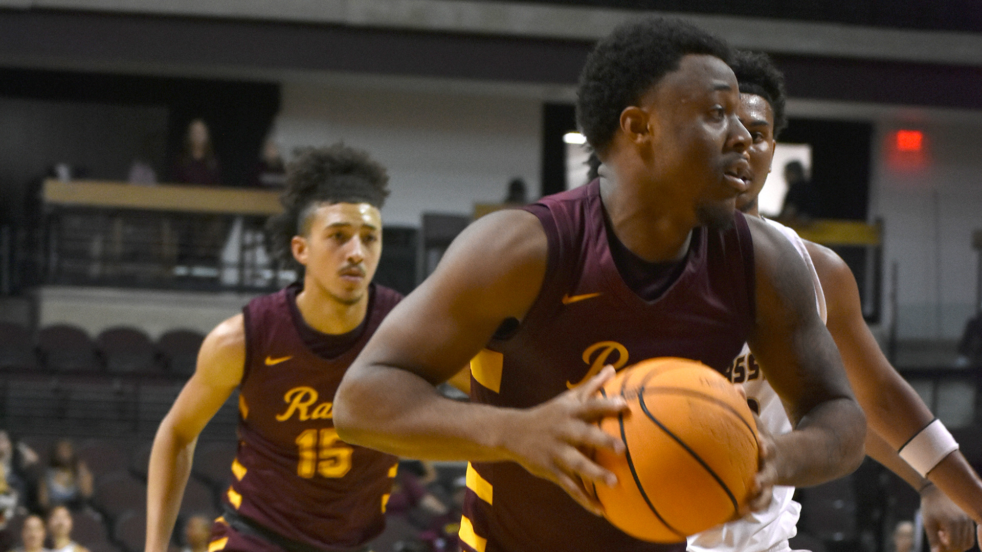 HT's Jaylen Streeter drives to the basket past a defender in a game earlier this season while teammate Eron Bogart looks on from behind the play