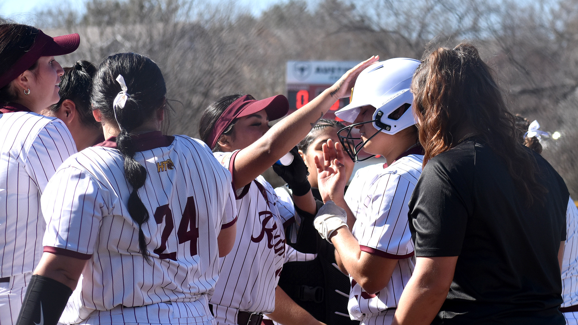 HT teammates congratulate Kayla Camacho after she homered in game one against Our Lady of the Lake