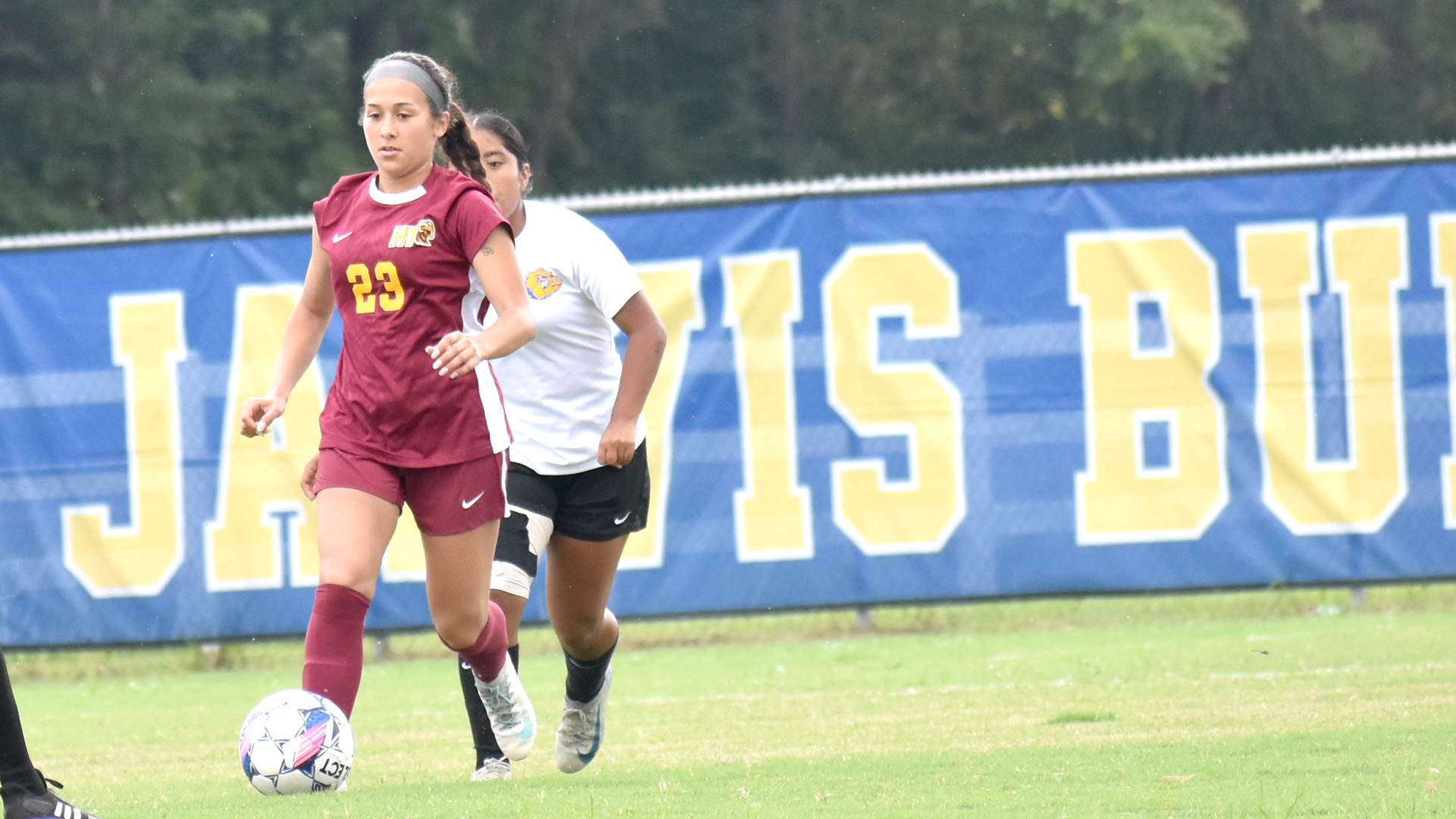 HT women's soccer player Caroline Valencia dribbles past a Jarvis Christian defender