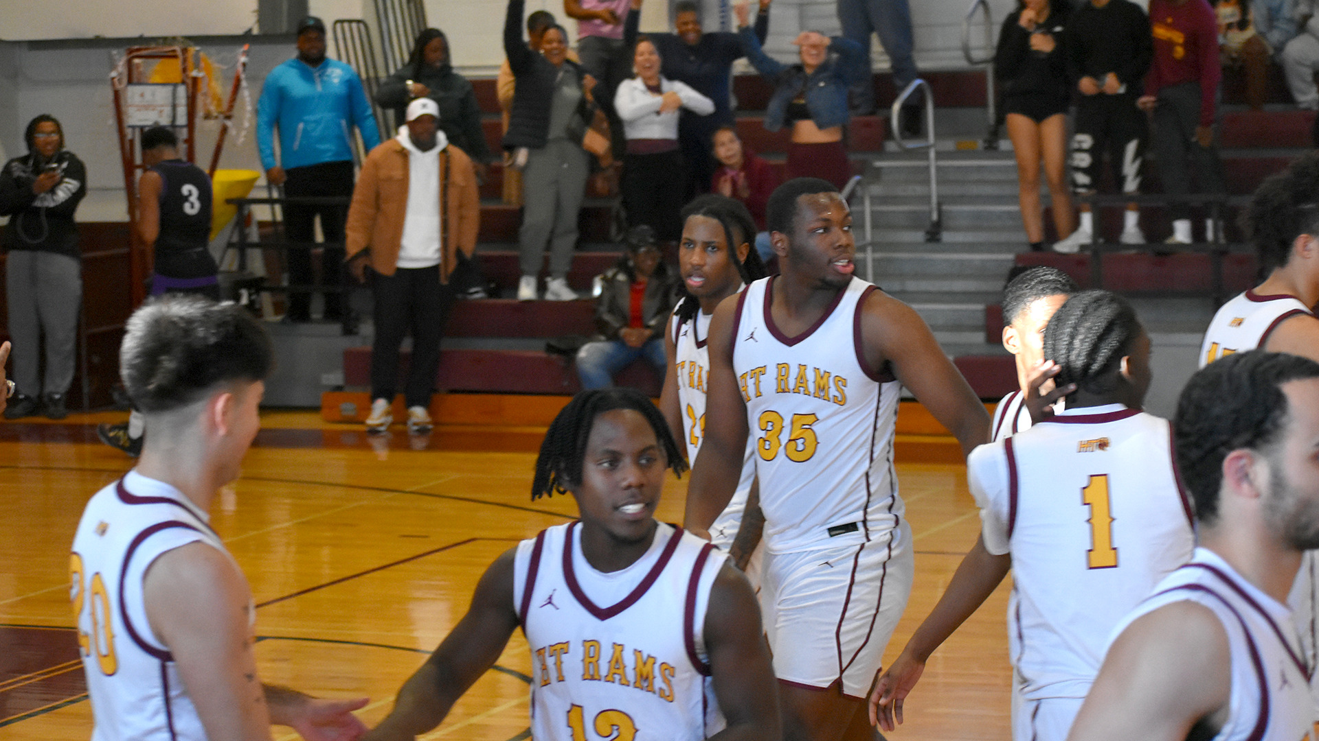 HT's men's basketball team celebrates its victory over Wiley in front of cheering fans at Branch Gymnasium