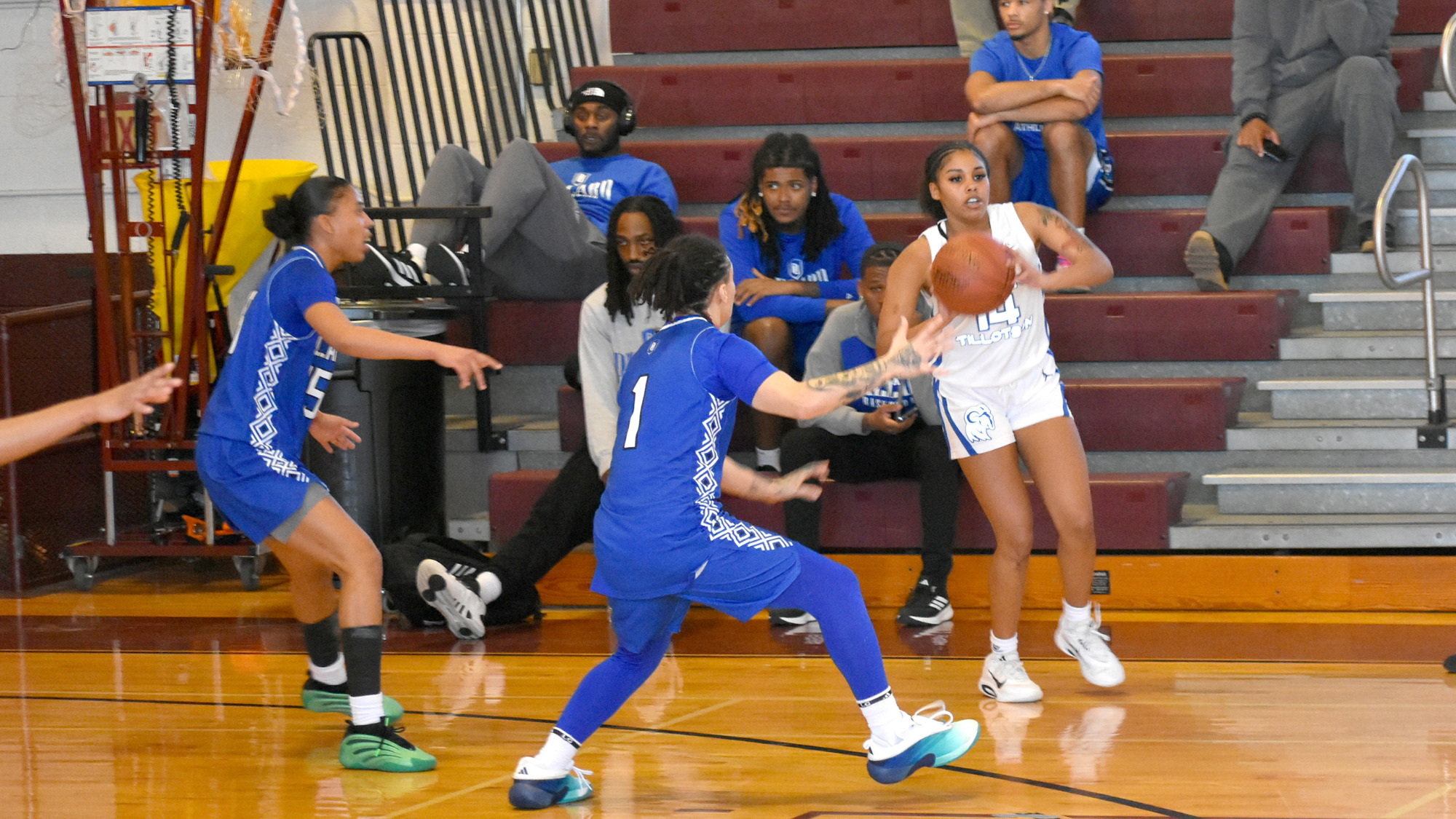 Jade Hilliary passes the ball to an HT teammate while being defended closely by two Dillard players