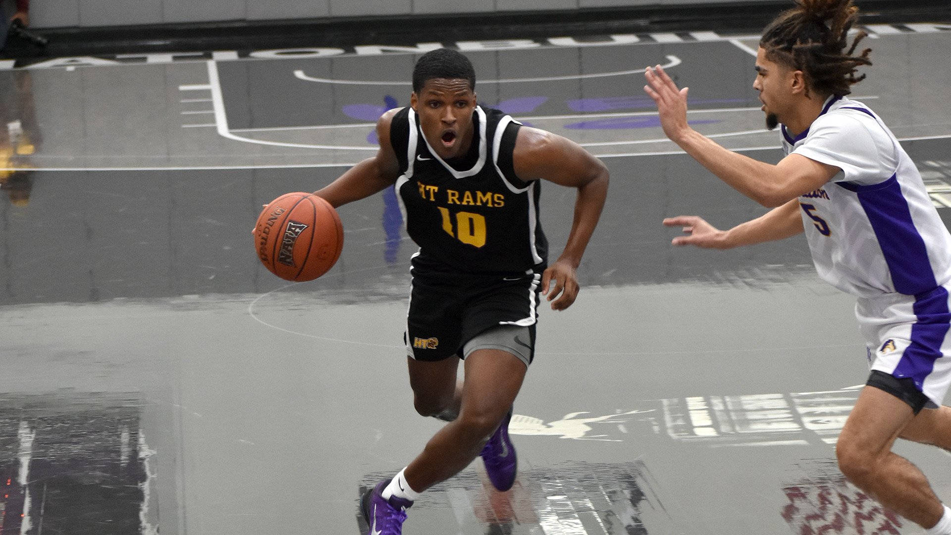 Blake Fisher dribbles past a defender to the basket in a game earlier this season