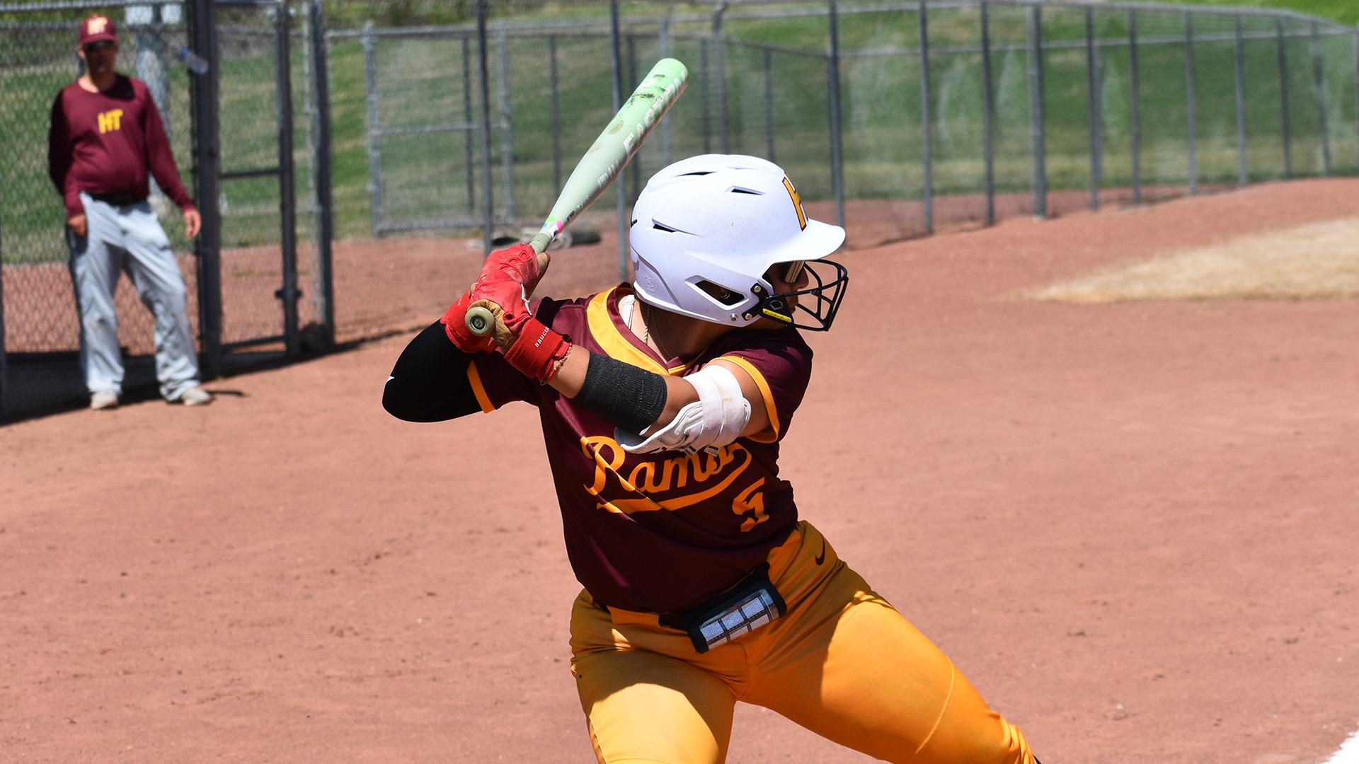 Alayali Alaniz bats right-handed at Oakwood University. HT head coach Tim Scherwin can be seen in the background.