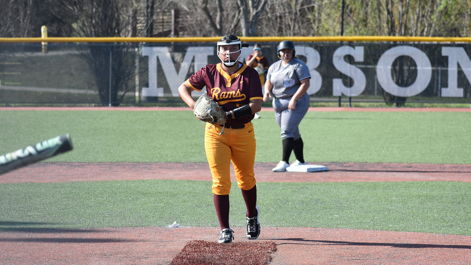 HT softball pitcher Marleigh Robinson prepares to pitch while a Voorhees runner stands on second base behind her