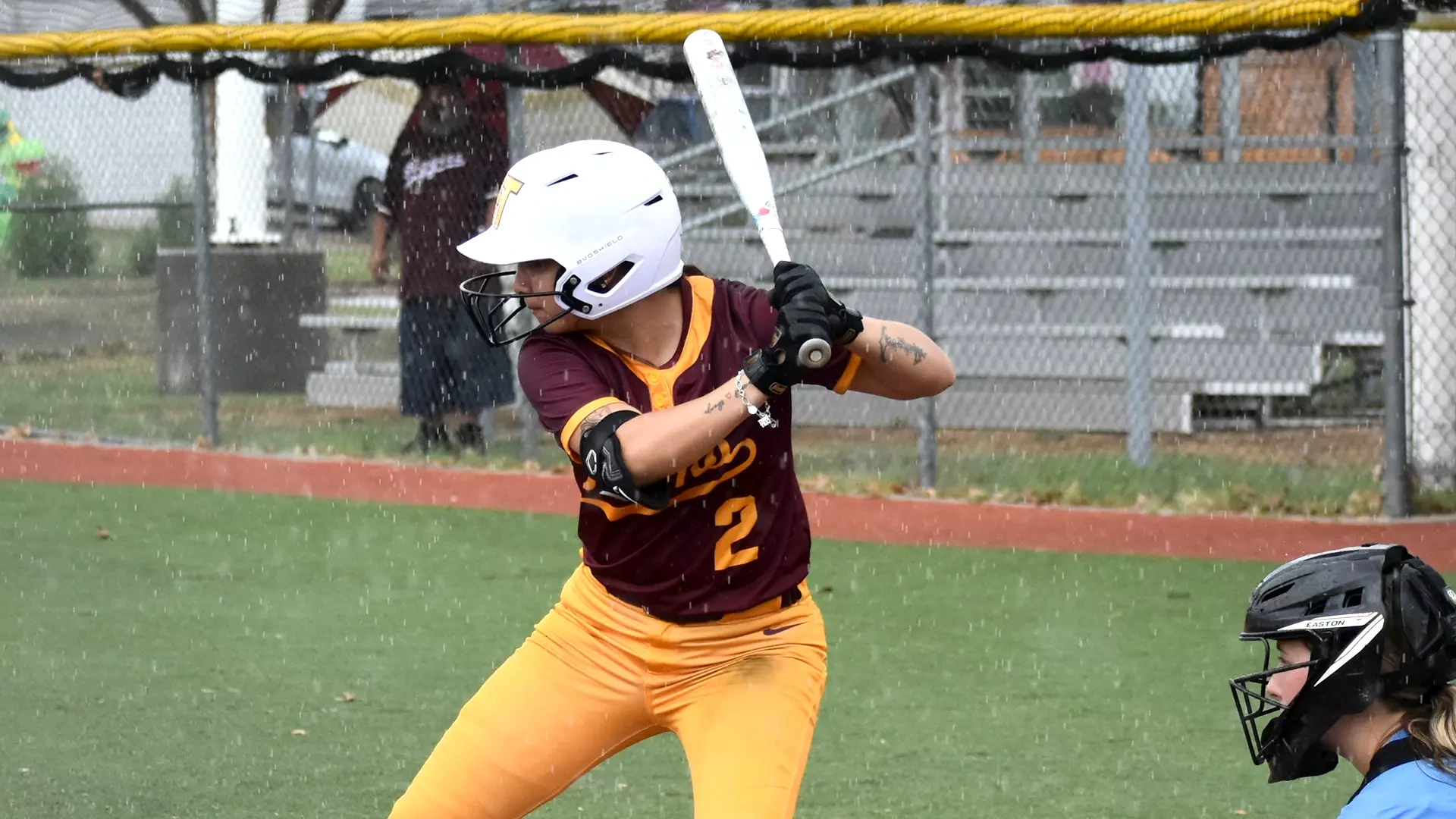HT softball player Alexis Gaona bats left-handed and waits for a pitch. The head of Talladega's catcher is visible in the bottom right of the picture.