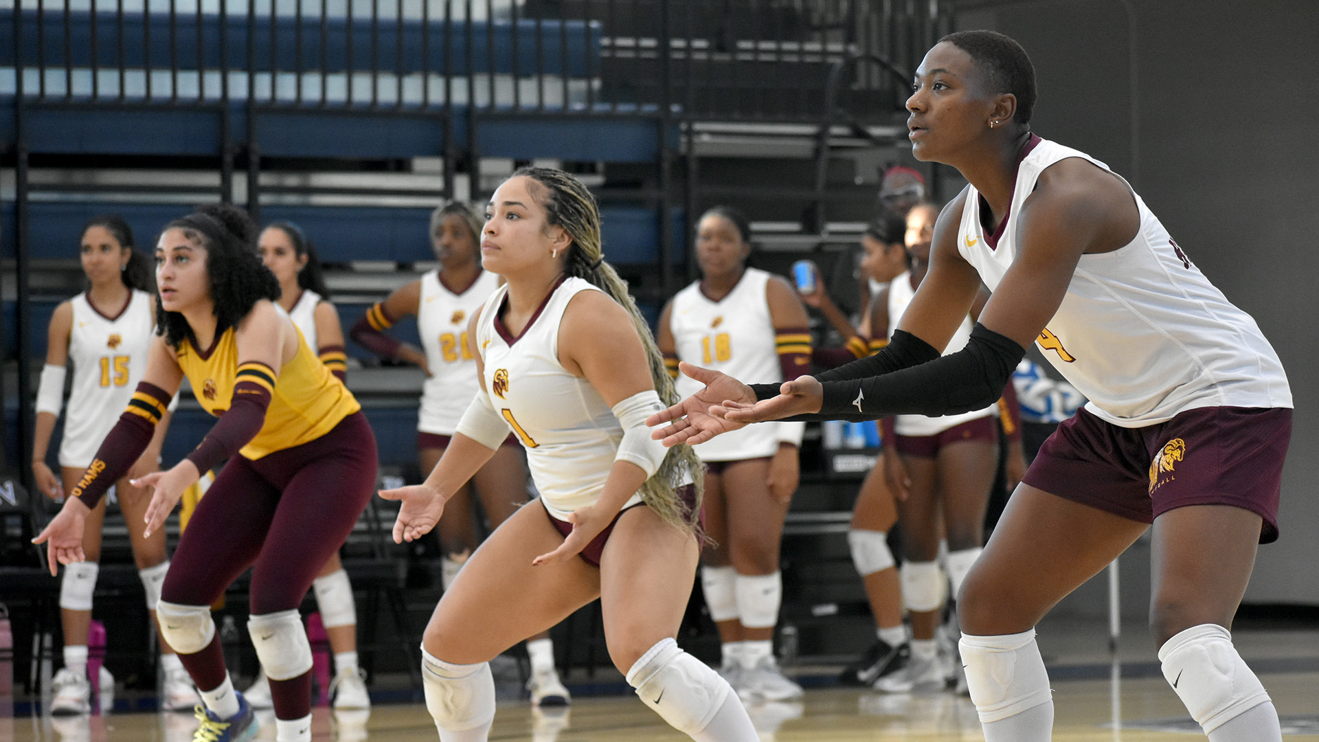 Aniyah Asberry (2), Gracie George (1), and Lindsey Morris (4) prepare to receive a serve in an HT volleyball match