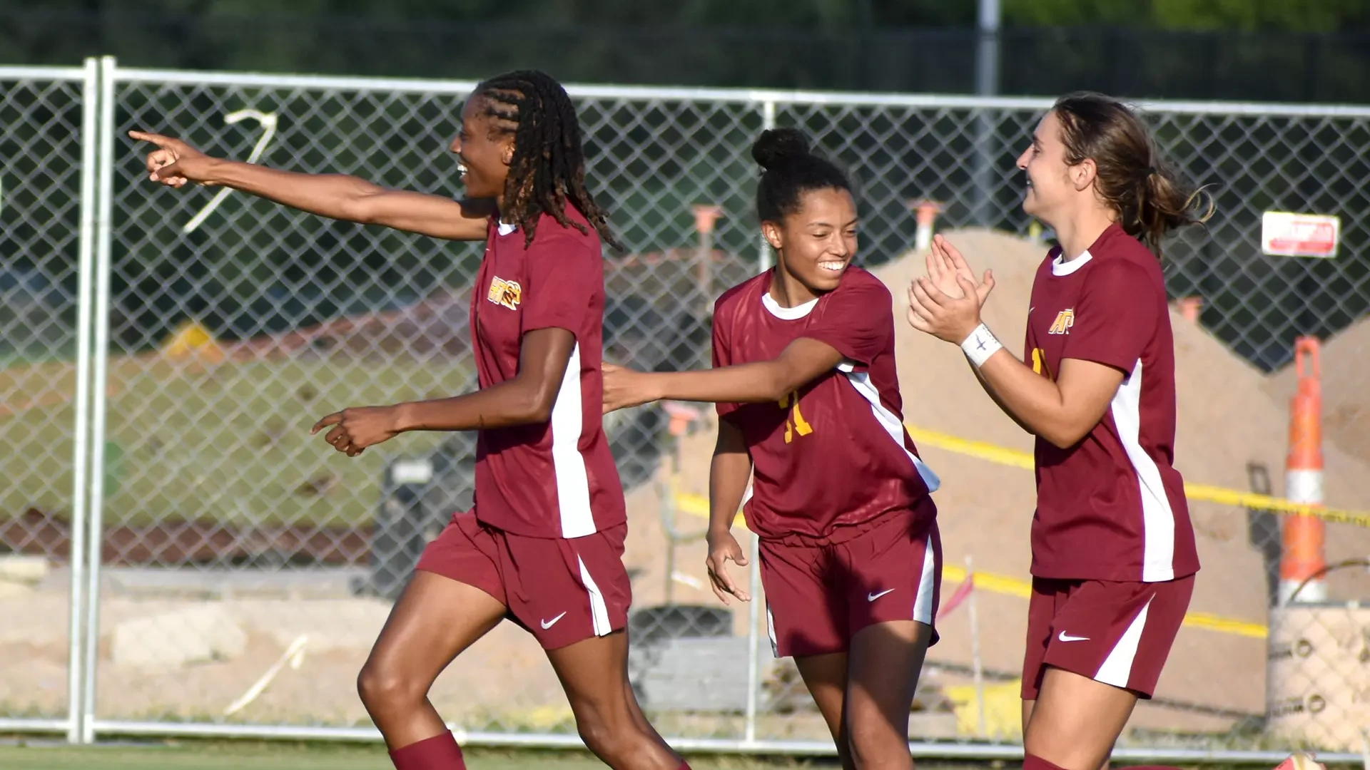 Mariyah McCrae points to her HT bench while teammates Sallie Buhr (middle) and Kamryn McMath (right) also celebrate McCrae's goal in a preseason 2026 contest