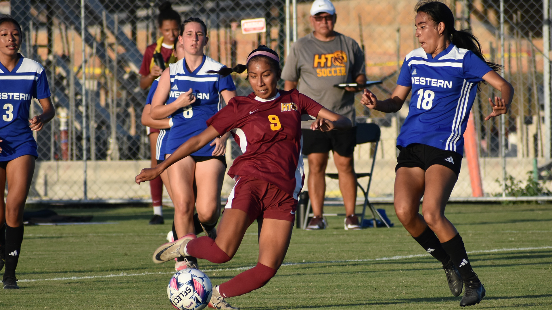 HT women's soccer player Krystal Trejo-Cristobal winds up to a kick a pass to a teammate through two defenders in a preseason match early in the 2026 season
