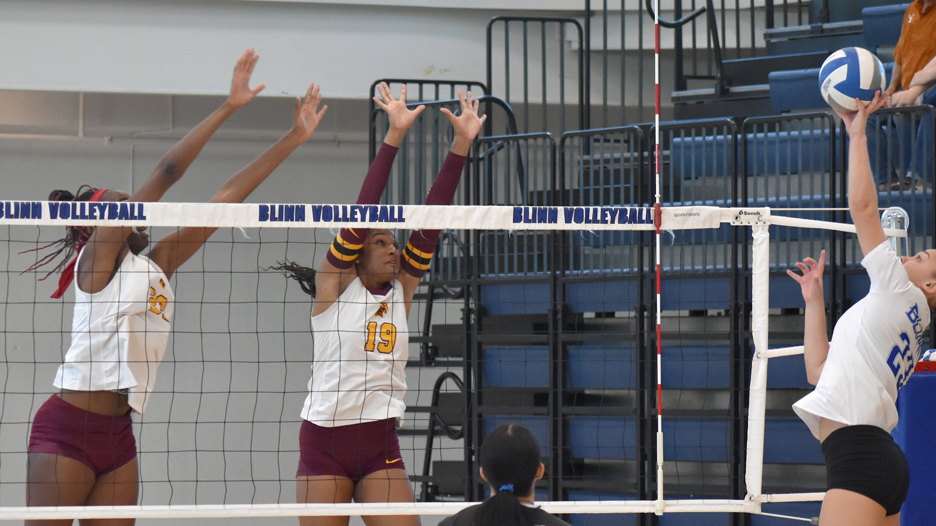 Brandi Edmonds (left) and Jada Arkadie (middle) attempt to block an opposition attack in a preseason contest