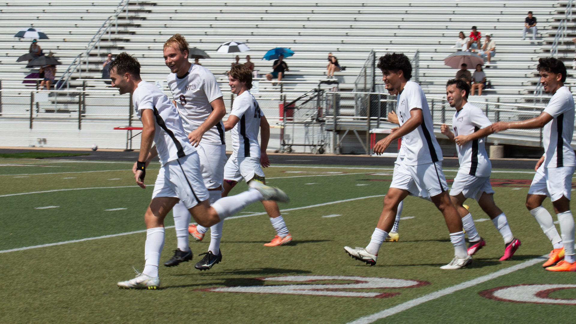 HT men's soccer defender Hank Sullins (foreground) is surrounded by teammates celebrating his first collegiate goal against Wayland Baptist