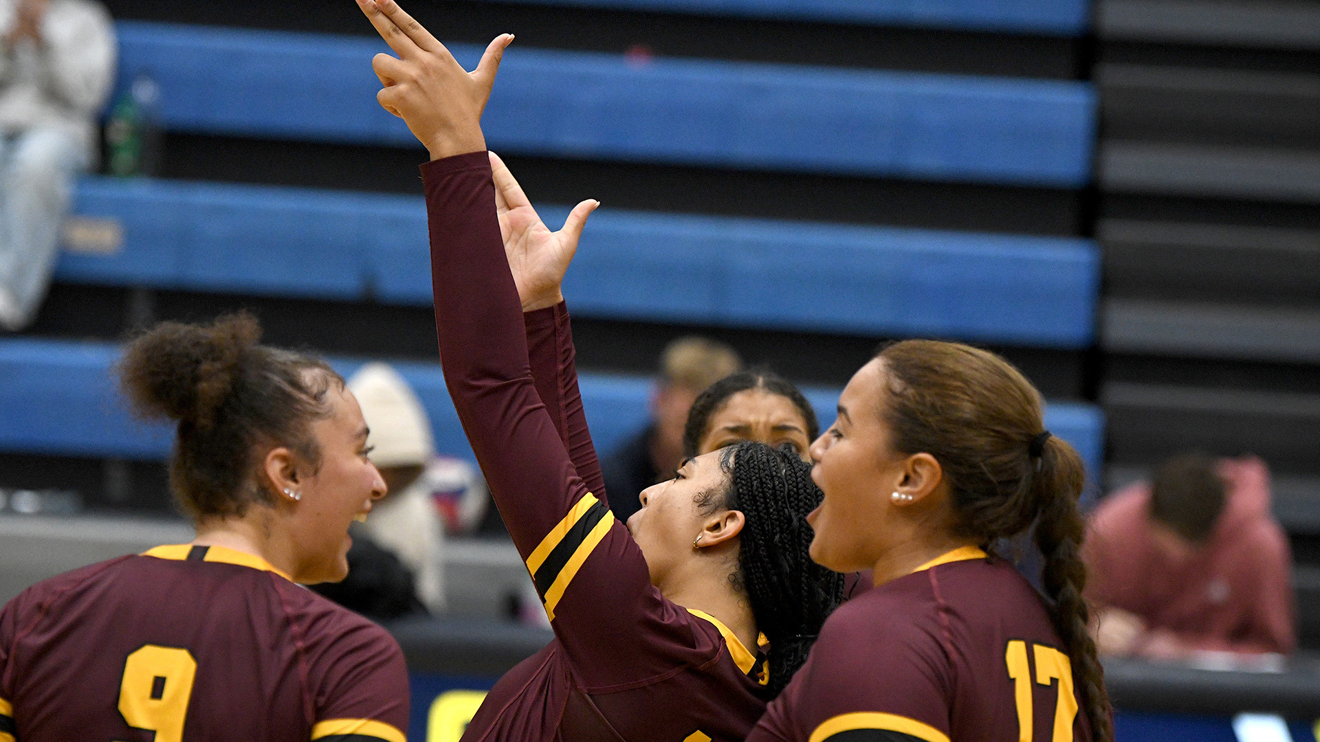 HT volleyball player Hayley Broussard points skyward while teammates Jordis Taylor and Addilynn Webb help her celebrate a big play at Clarke University's Home Tournament