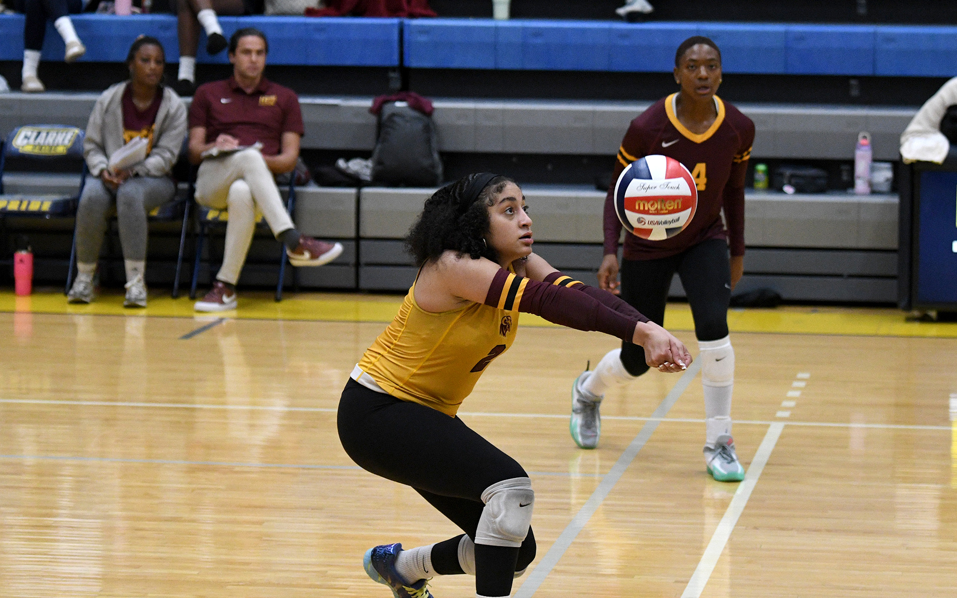 Aniyah Asberry (2) digs an opposition attack while HT teammate Lindsey Morris (4) waits for an attack attempt