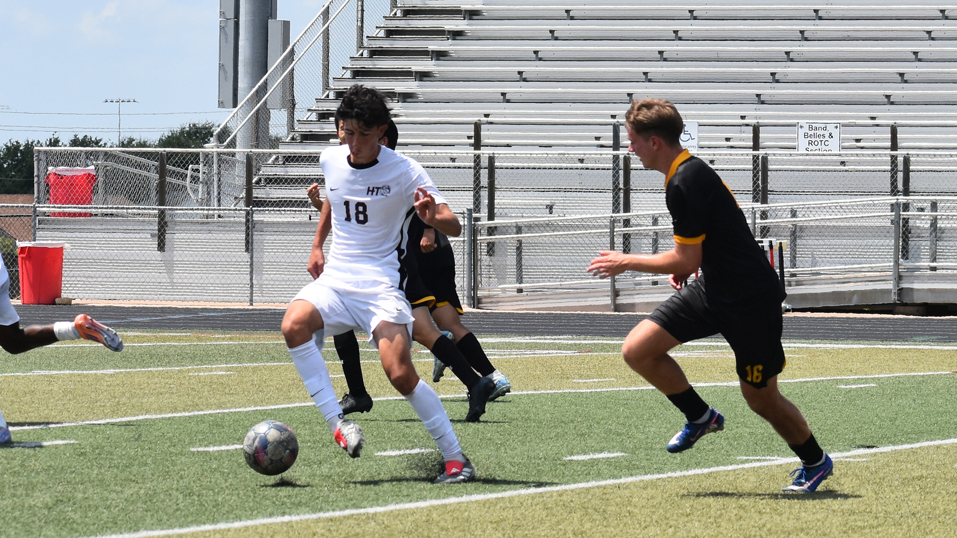 HT men's soccer player Gavin Latas (18) tries to control the ball and dribble past Wayland Baptist defenders (Aug. 29, 2026)