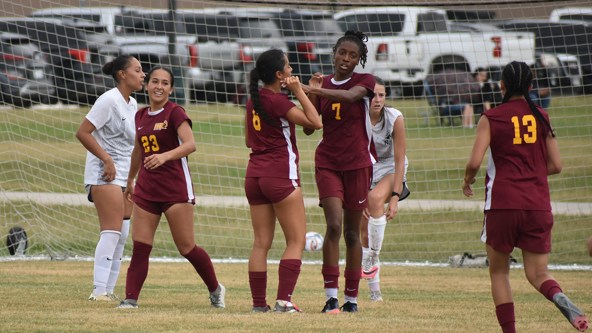 Mariyah McCrae (7) is congratulated by her HT women's soccer teammates after scoring a first-half goal at North American University