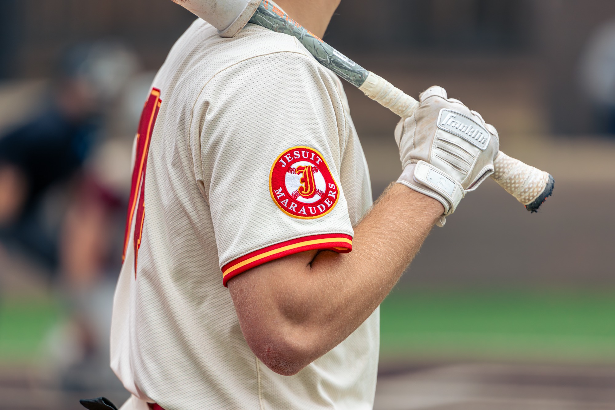 Close-up of the Jesuit Marauders sleeve patch on a Jesuit High School batter's uniform during the varsity baseball game against Whitney High School on April 20, 2026.
