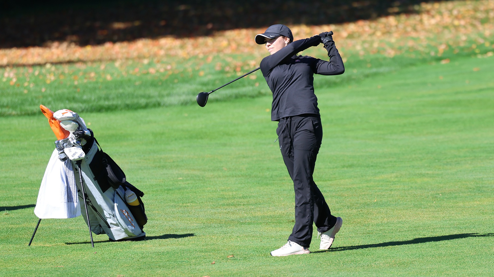 Kalamazoo College women's golfer playing golf