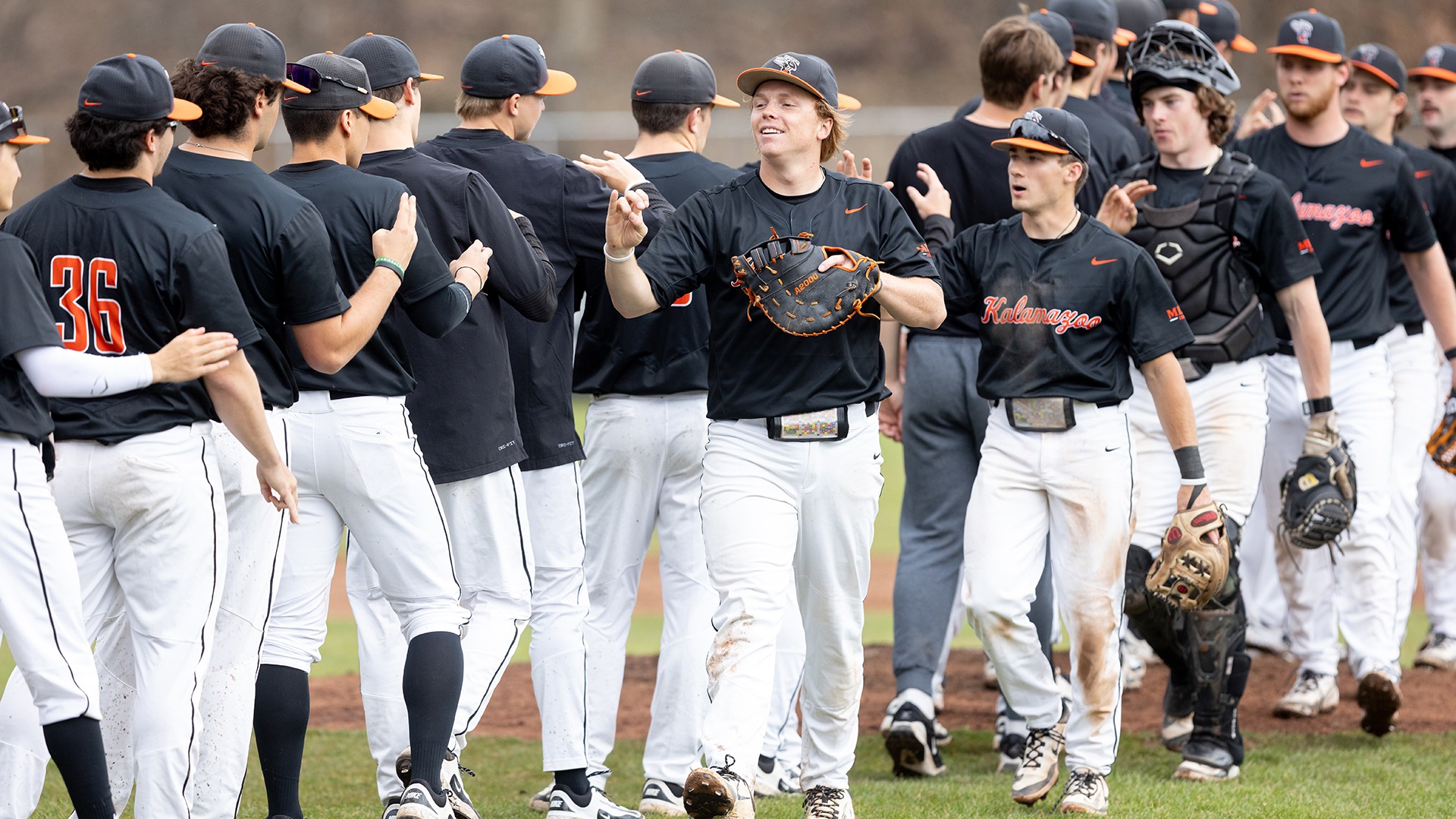 Kalamazoo College baseball team high-fiving after a game.