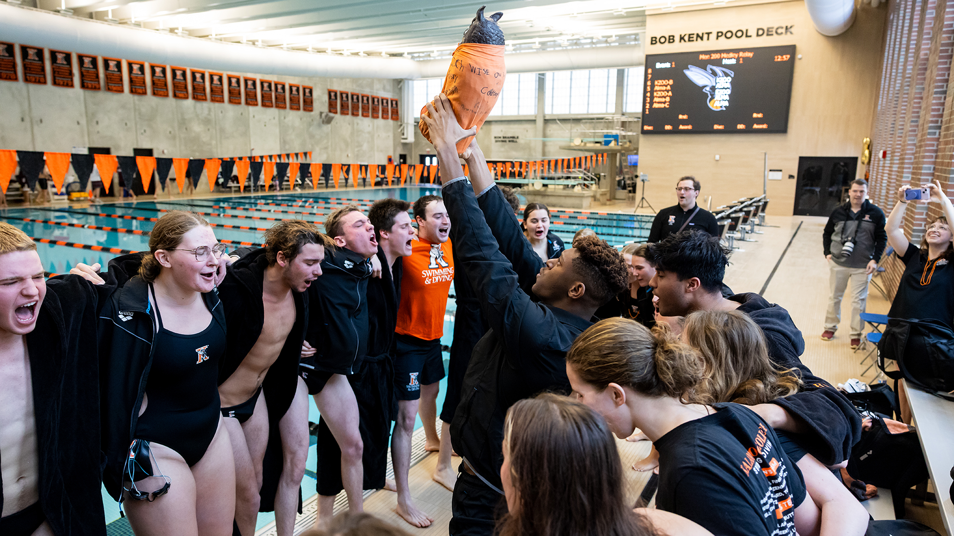 Christopher Trustin leading the Kalamazoo College swimming and diving team cheer