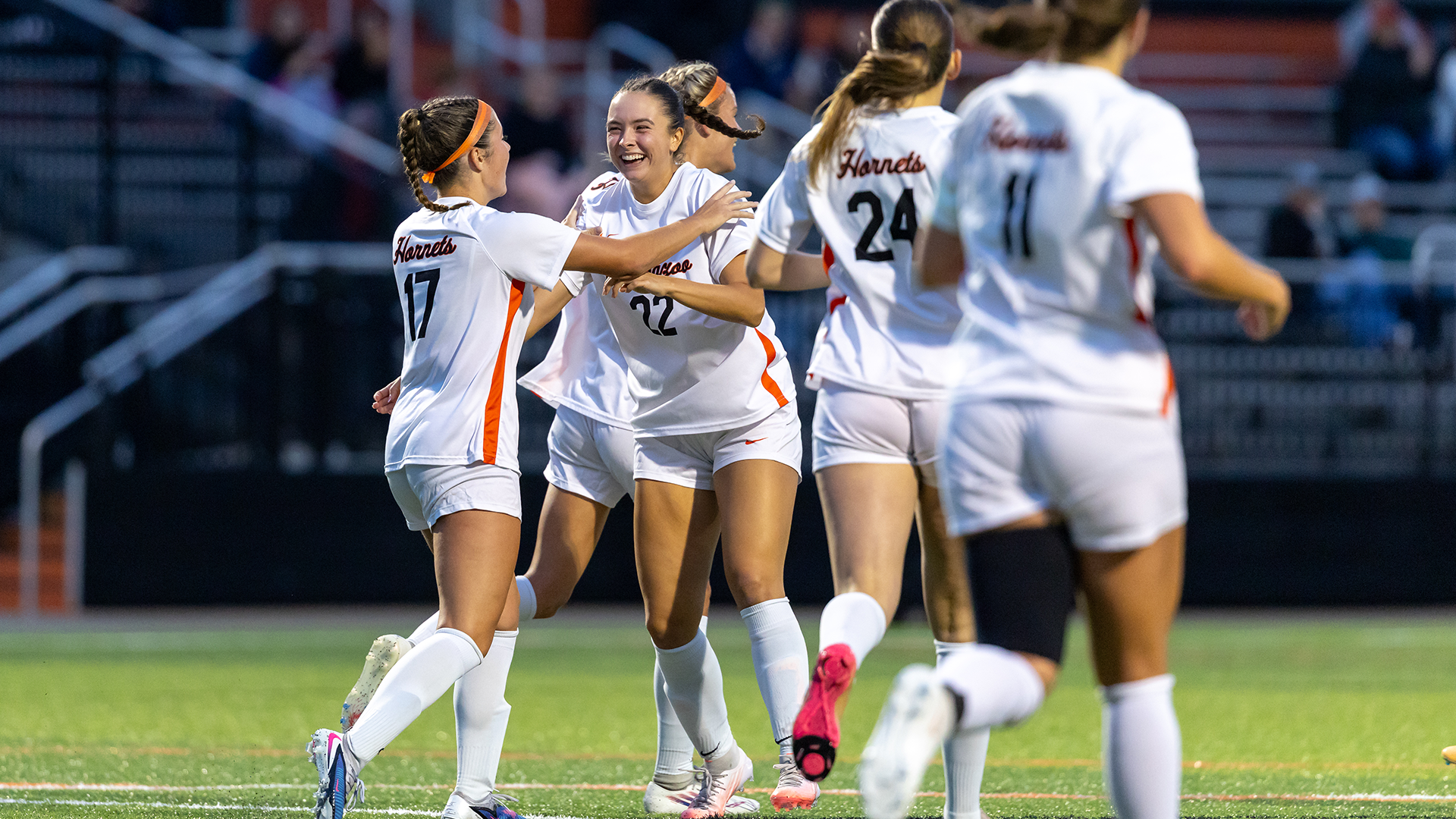 Savannah Norman celebrates a goal with her Kalamazoo College women's soccer teammates