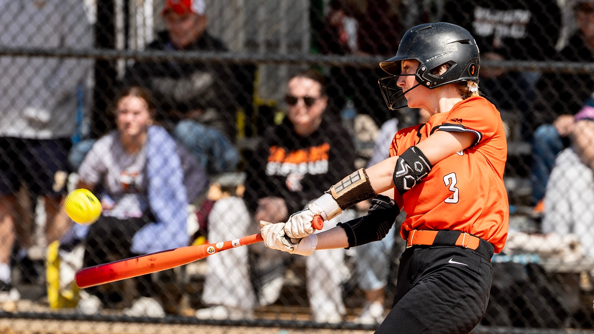 Lily Evans hitting a softball