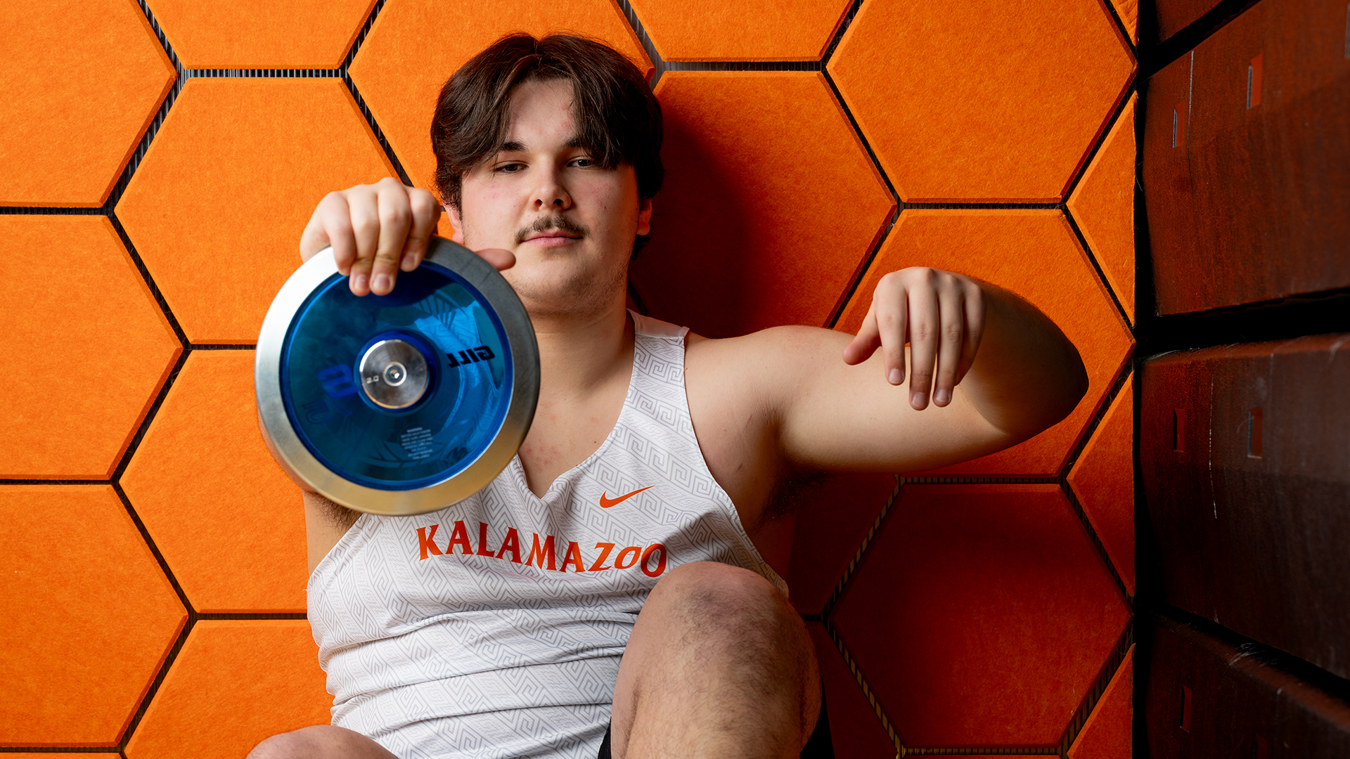 Ethan Romey posing with a discus