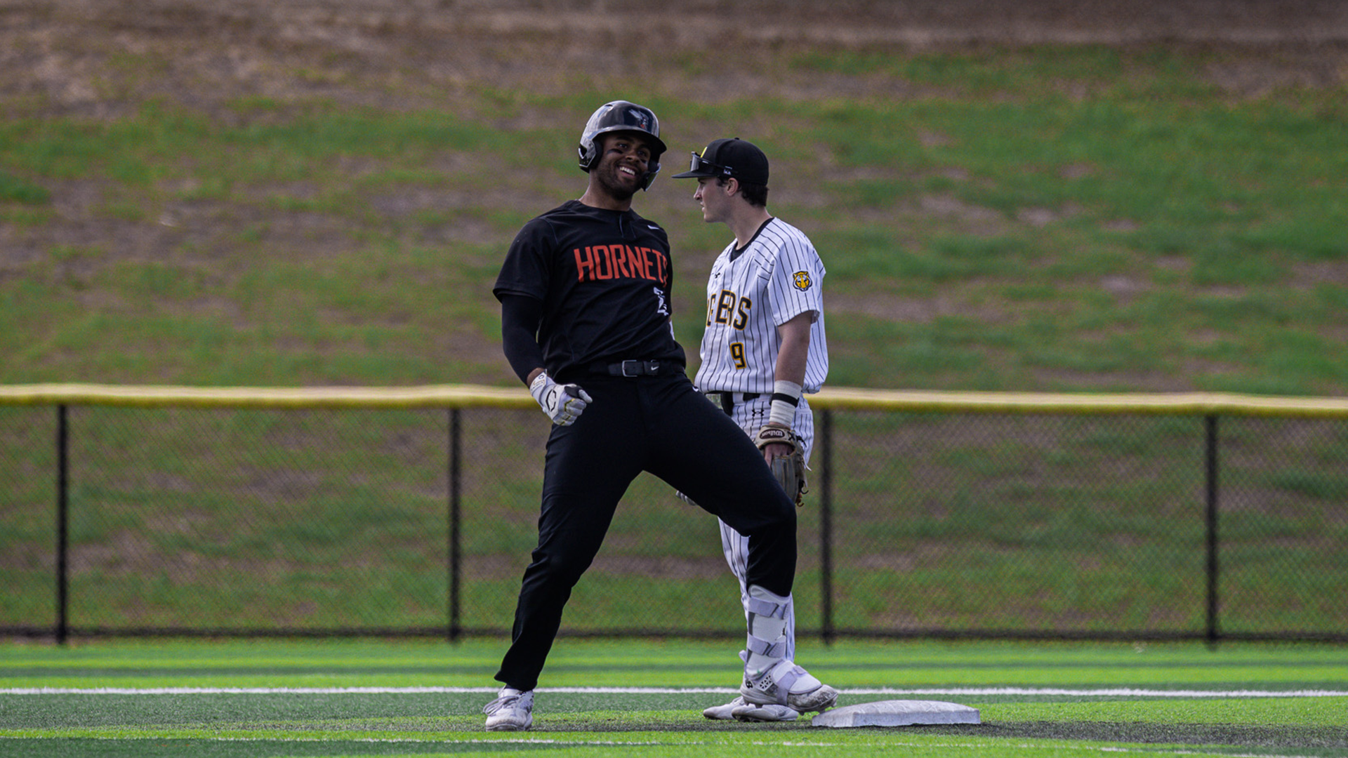 Robert Newland smiling at second base after hitting a double