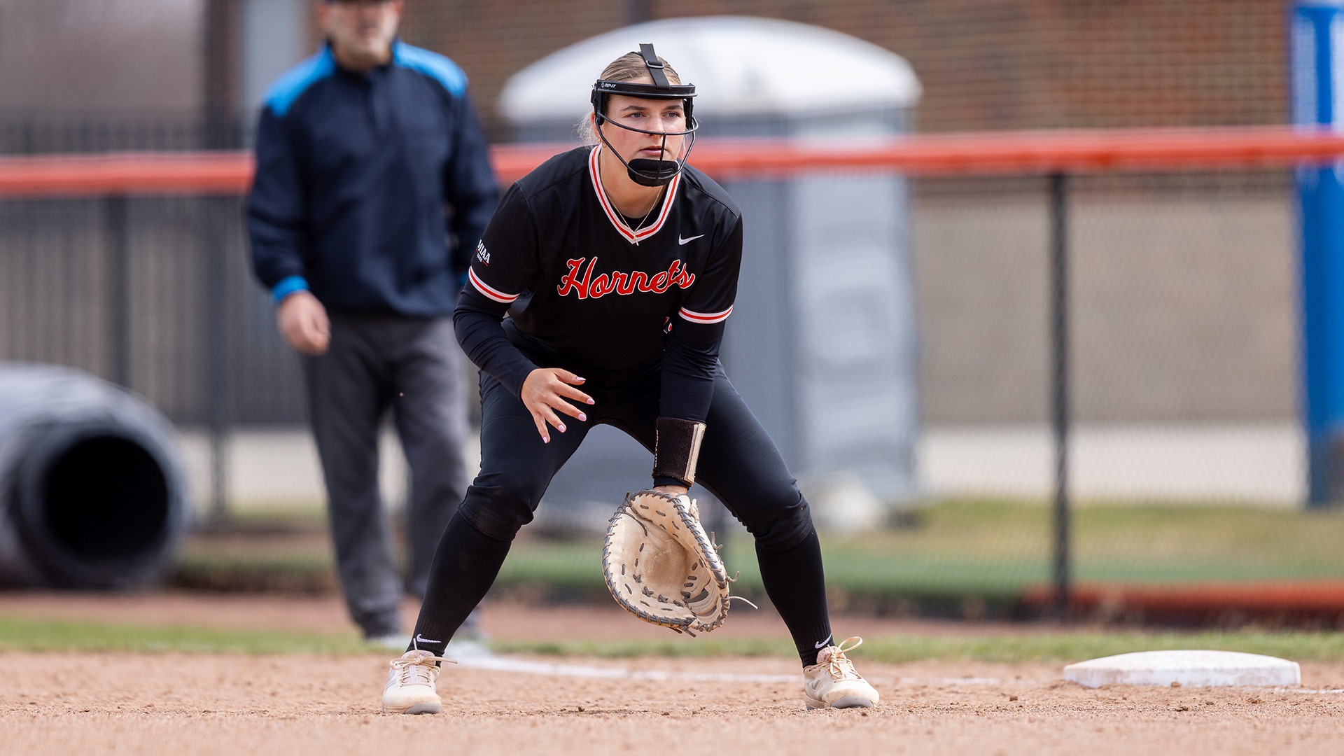Kalamazoo College softball player playing first base