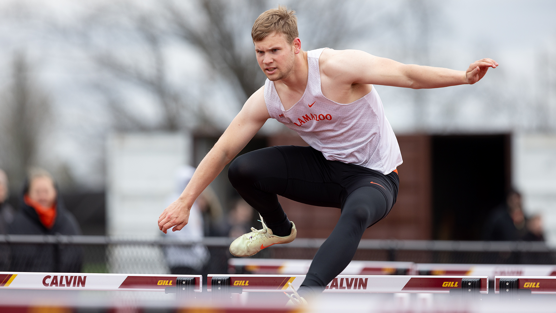 Logan Coller jumping over a hurdle