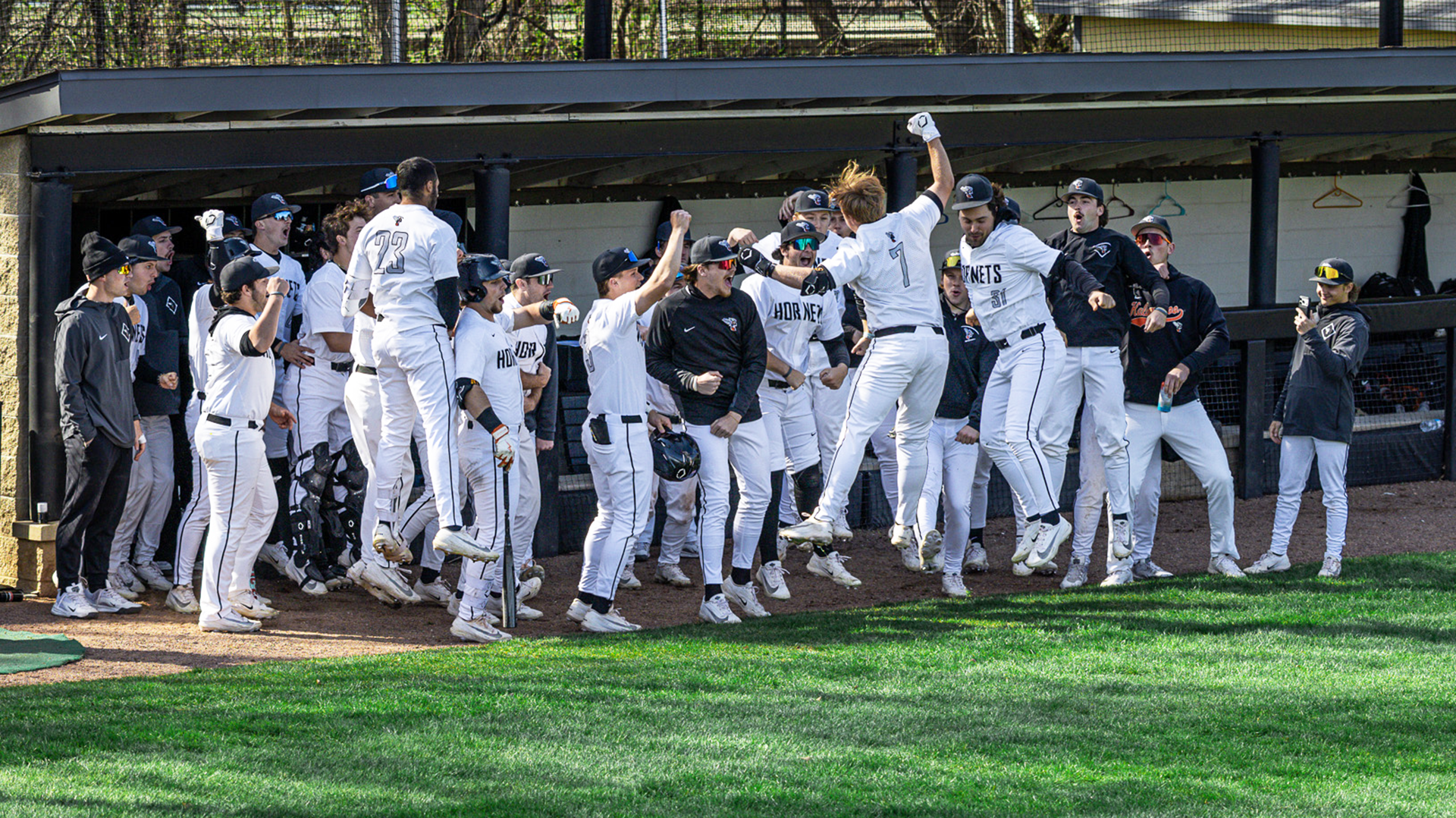 The Kalamazoo College baseball team celebrating a home run