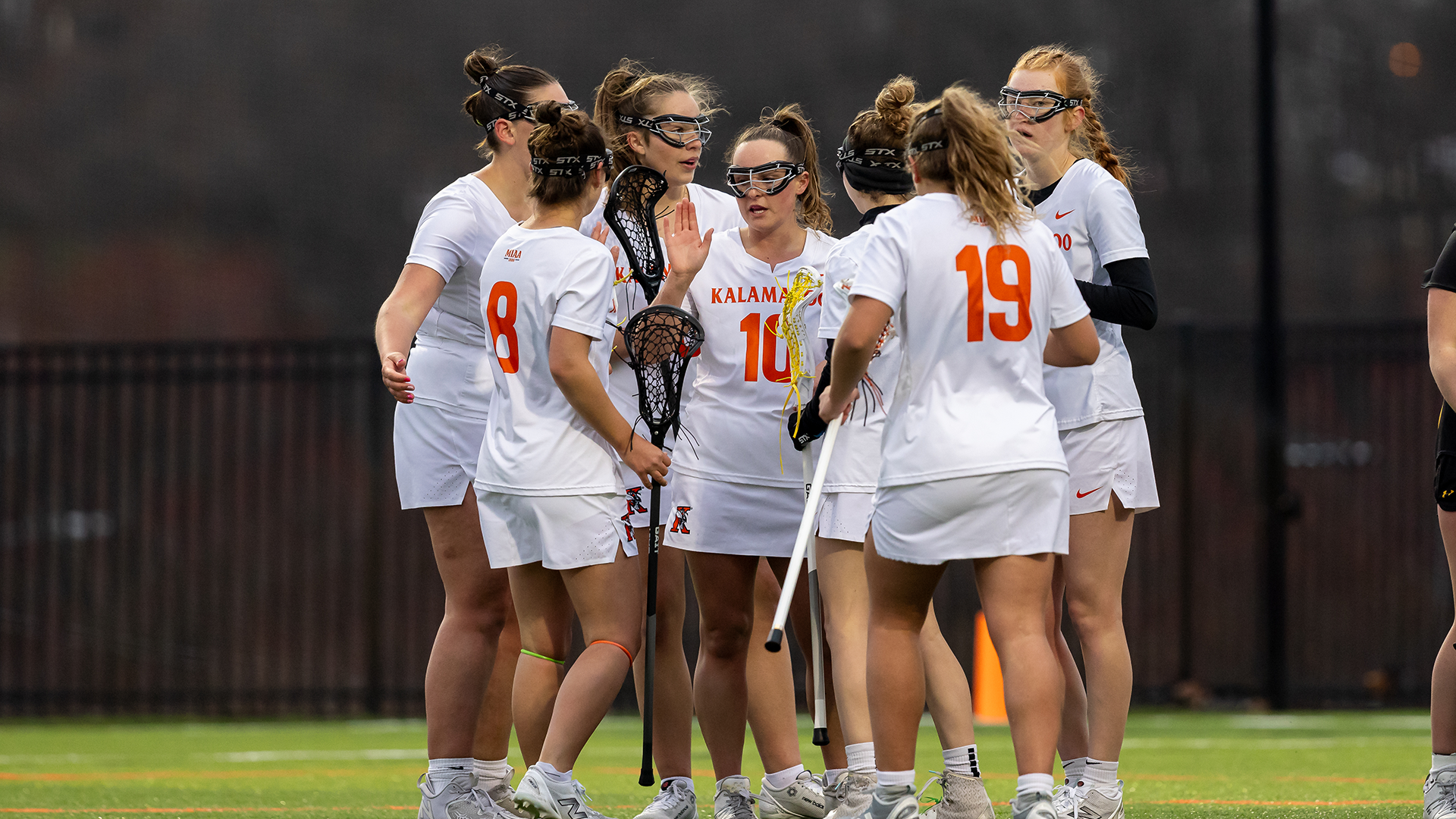 The Kalamazoo College women's lacrosse team huddled on MacKenzie Field