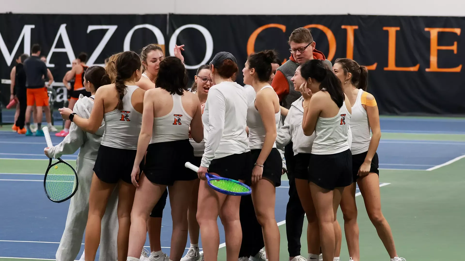 The Kalamazoo College women's tennis team huddled up in Markin Tennis Center