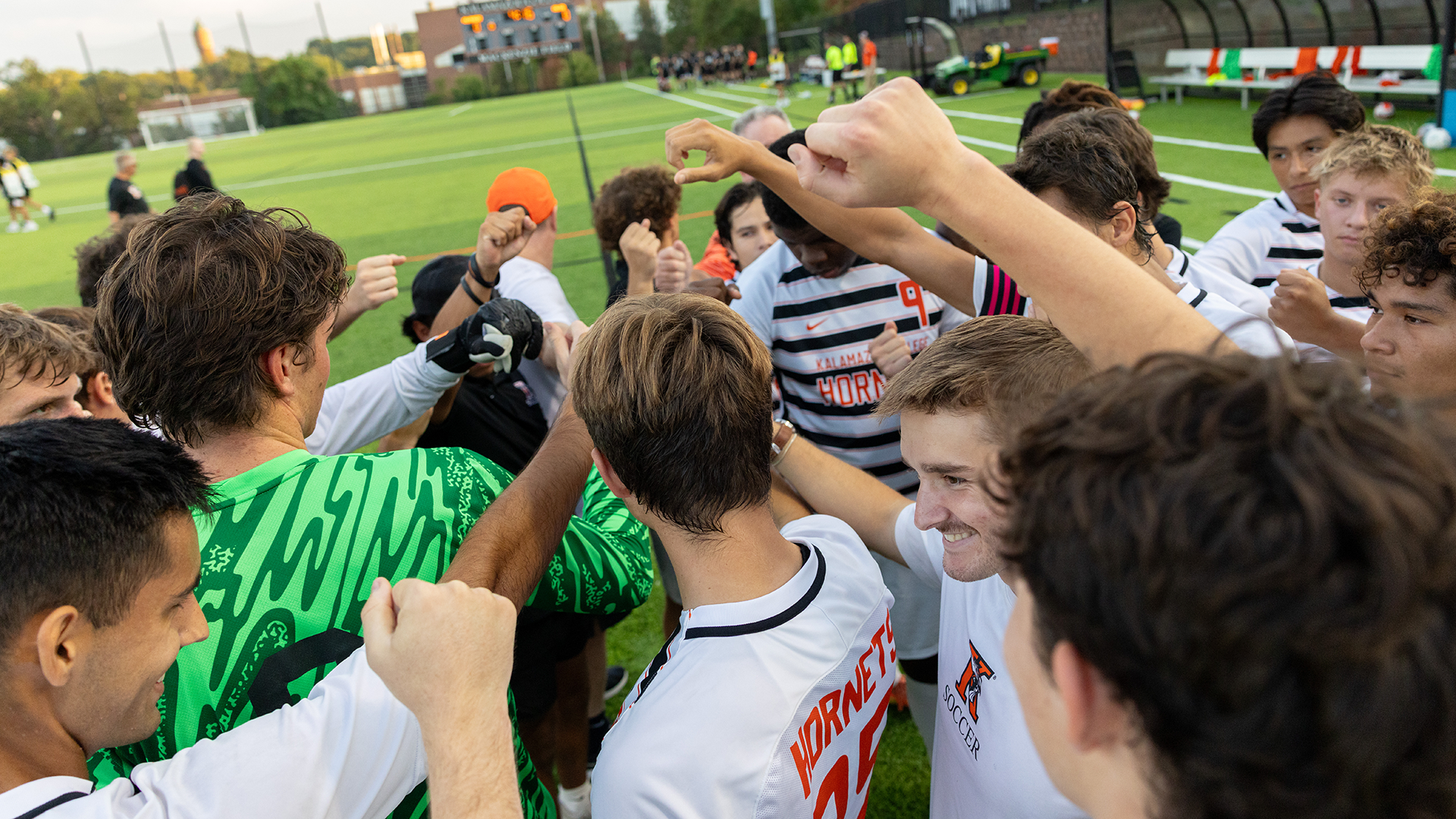The Kalamazoo College men's soccer team huddled on MacKenzie Field