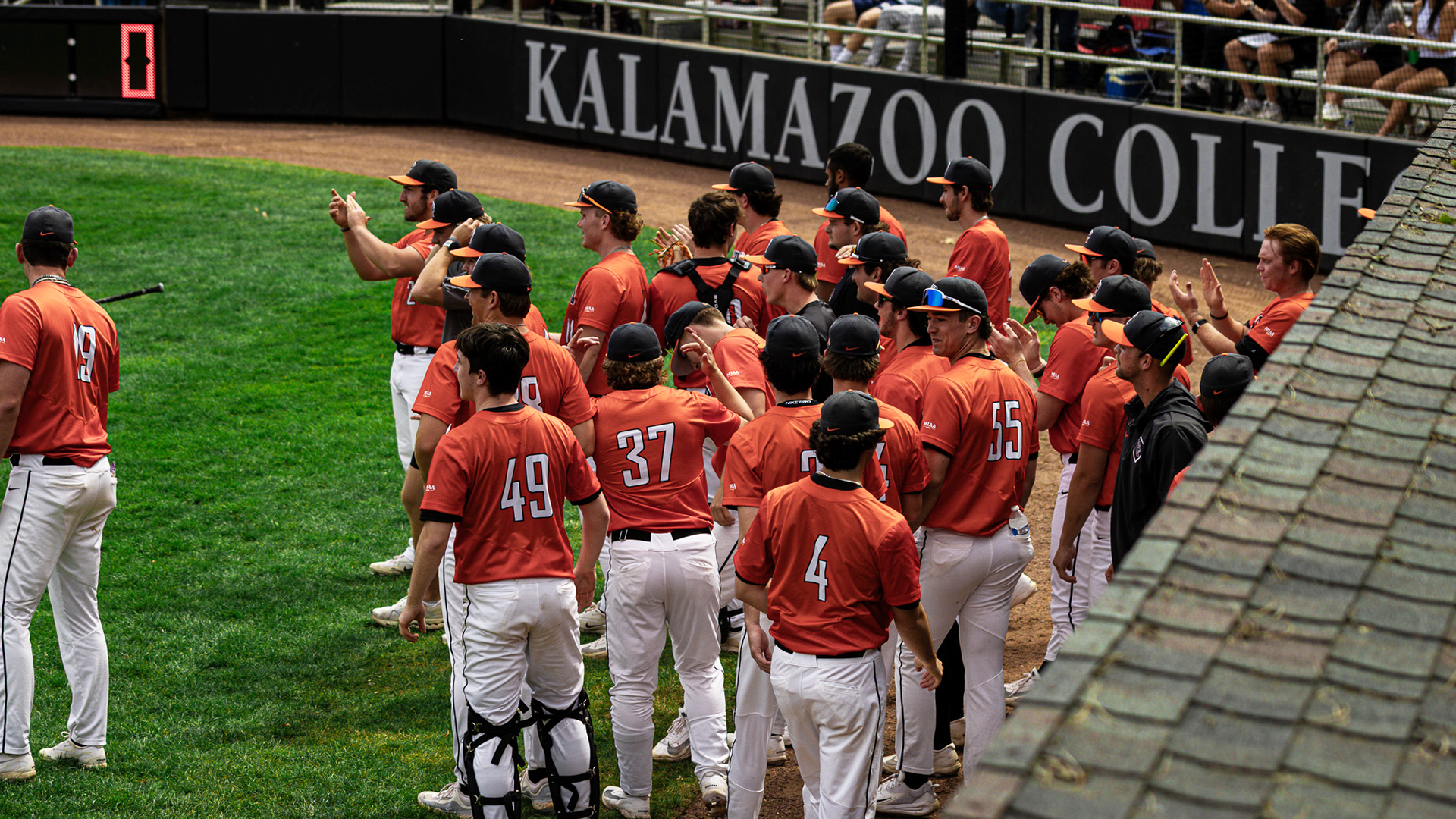 The Kalamazoo College baseball team celebrating a home run