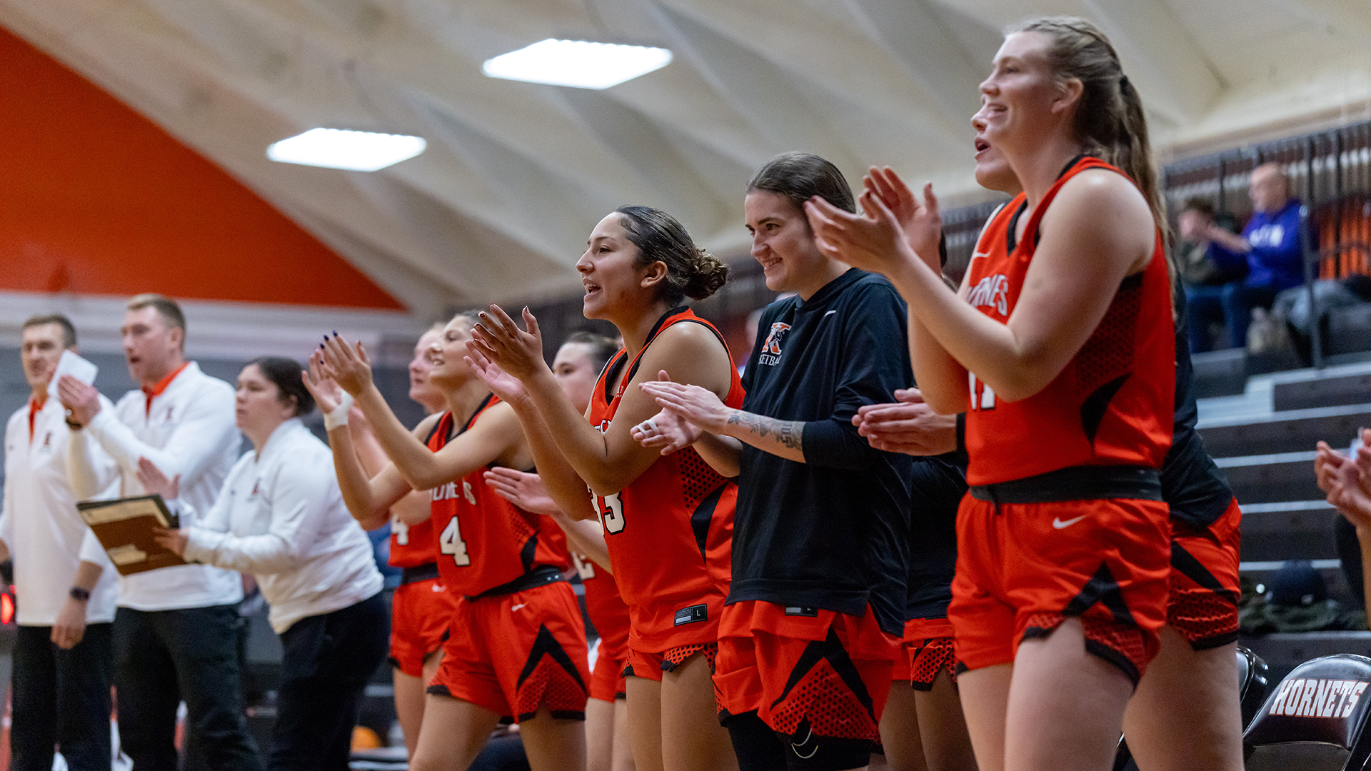 The Kalamazoo College women's basketball team celebrating a made basket