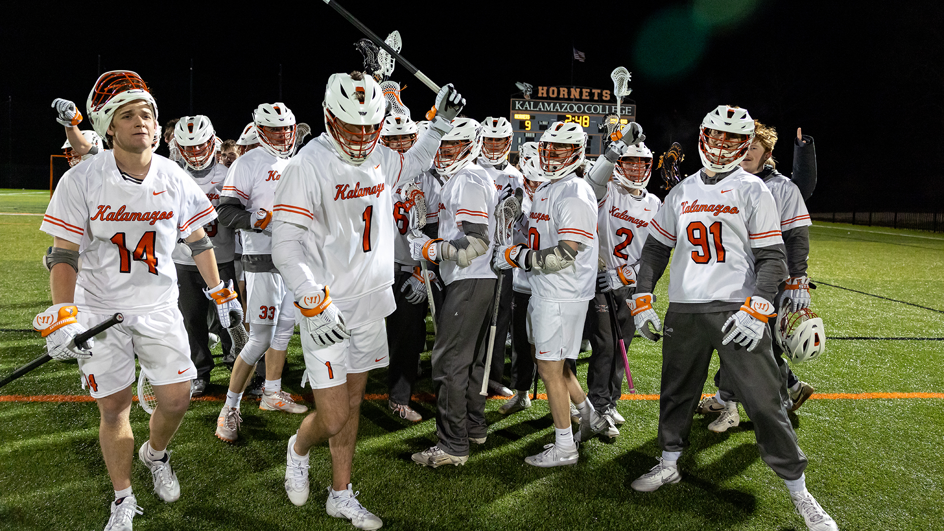 The Kalamazoo College men's lacrosse team celebrating a win on MacKenzie Field