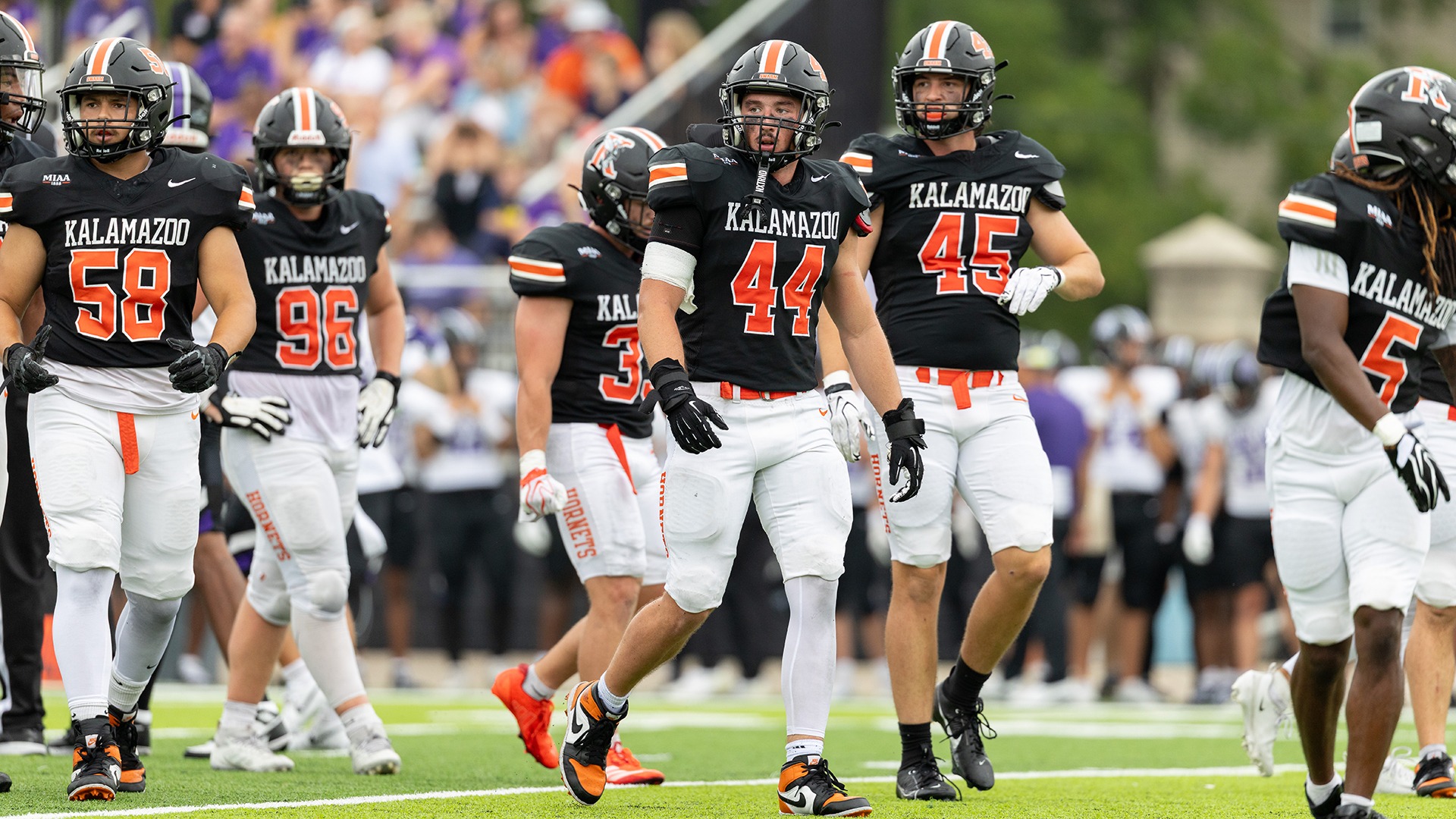 Kalamazoo College football players on field