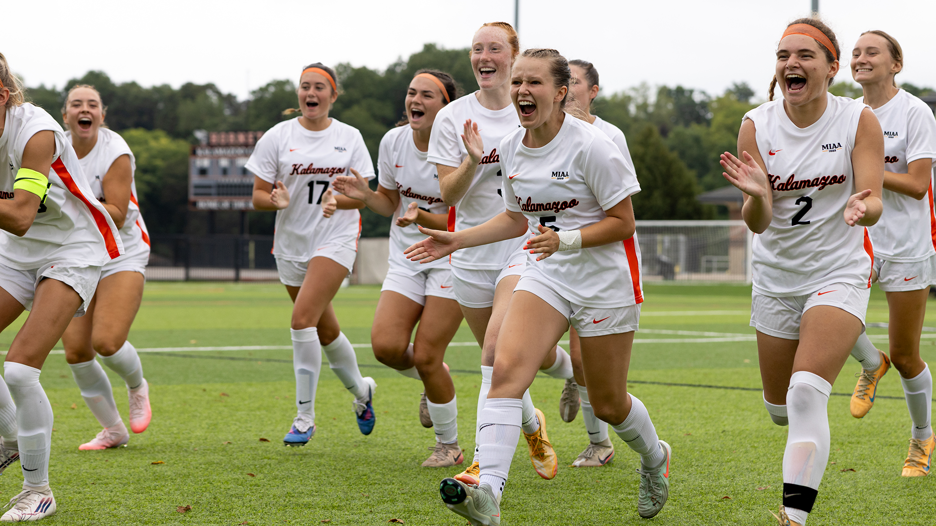 The Kalamazoo College women's soccer team cheering on MacKenzie Field