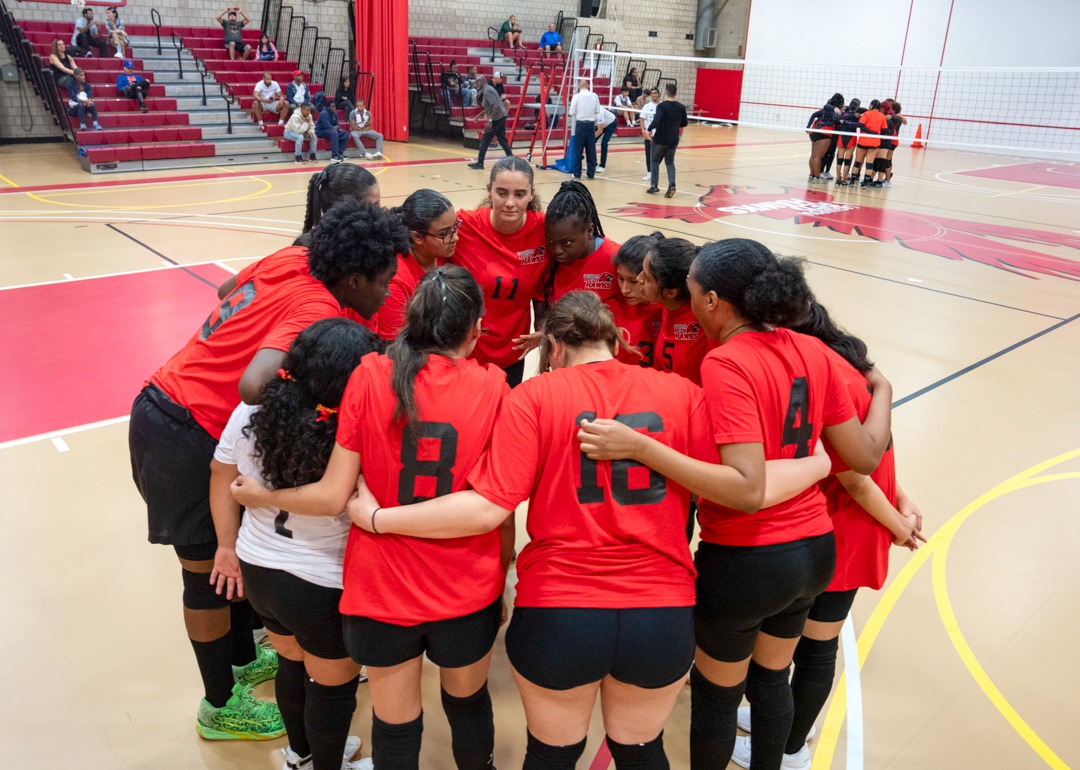 The Red Hawks huddle up before taking the court for their first game 