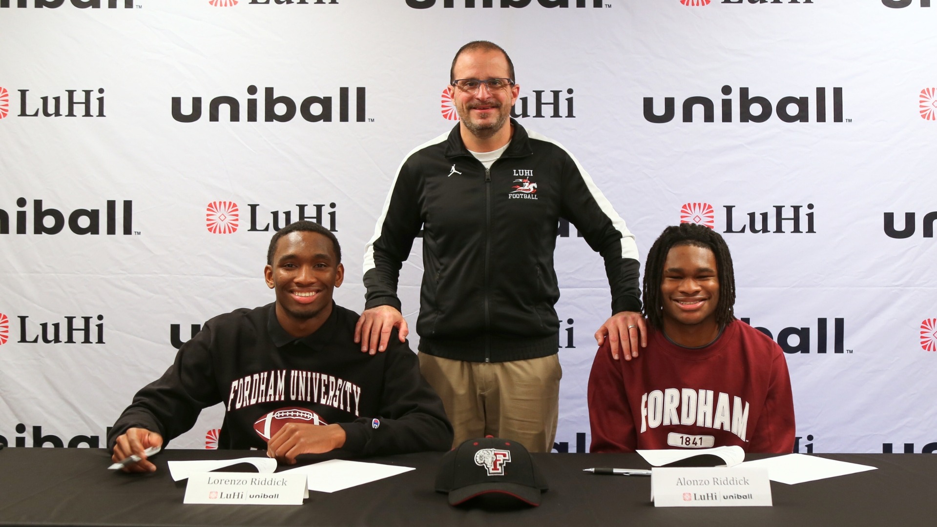 Lorenzo & Alonzo Riddick, and Coach Reno during their signing