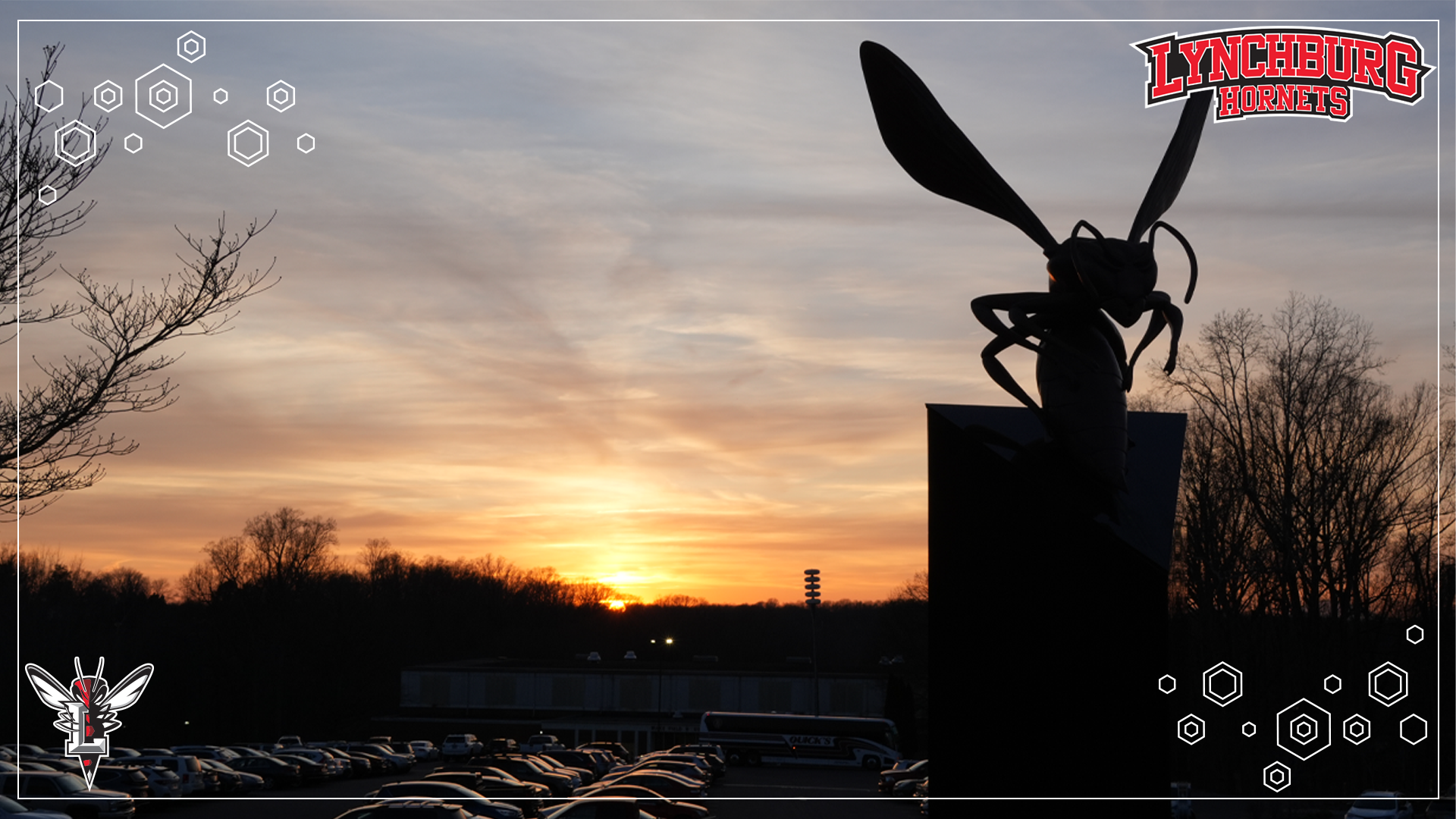 Silhouette of a Hornet statue with an orange sunset behind it