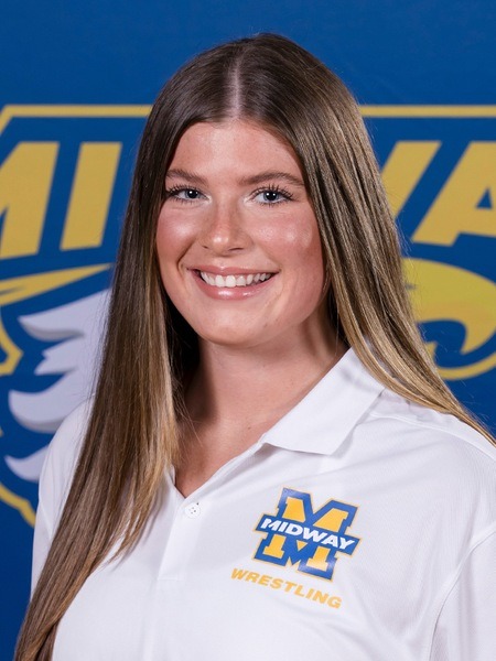 Smiling young woman in white Midway polo shirt with long straight hair.