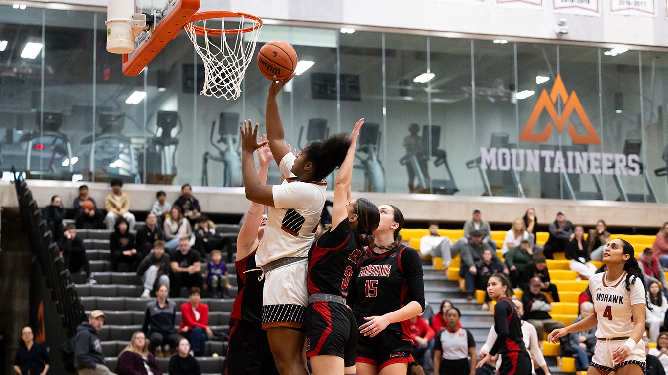Tiffany Williams going up versus multiple Fanshawe defenders