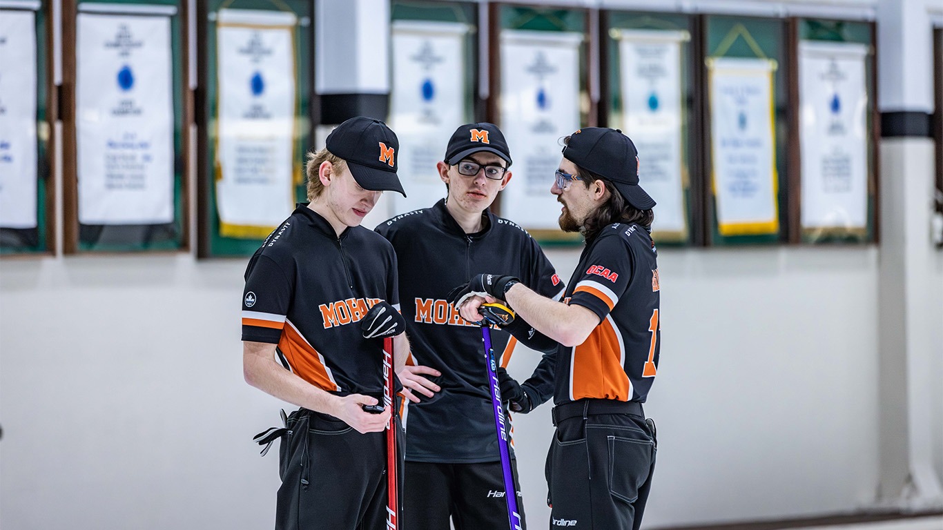 Men's curling team in discussion