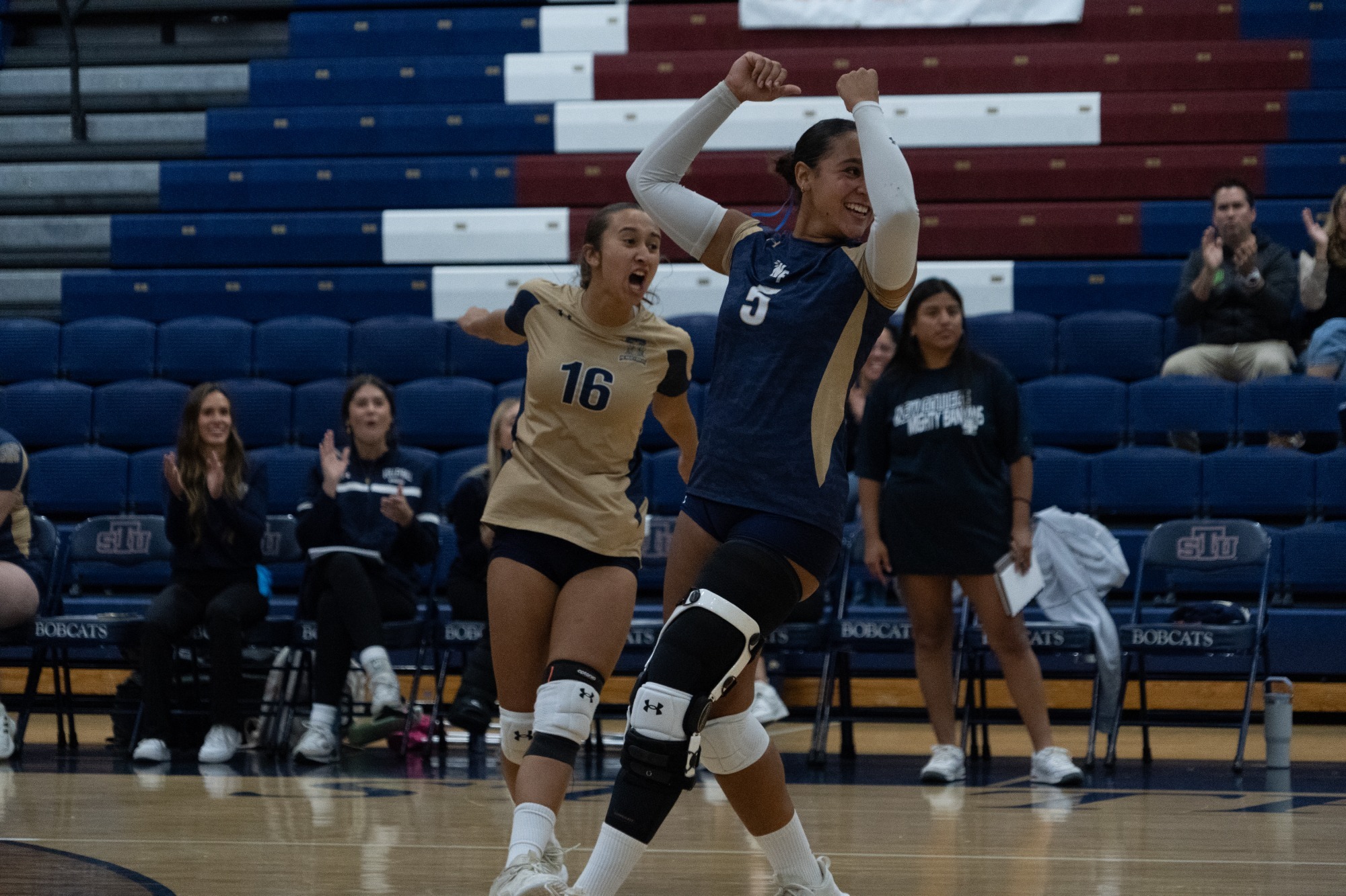 Soroya Nacero and Maria Luiza Barreis celebrate a point at St. Thomas