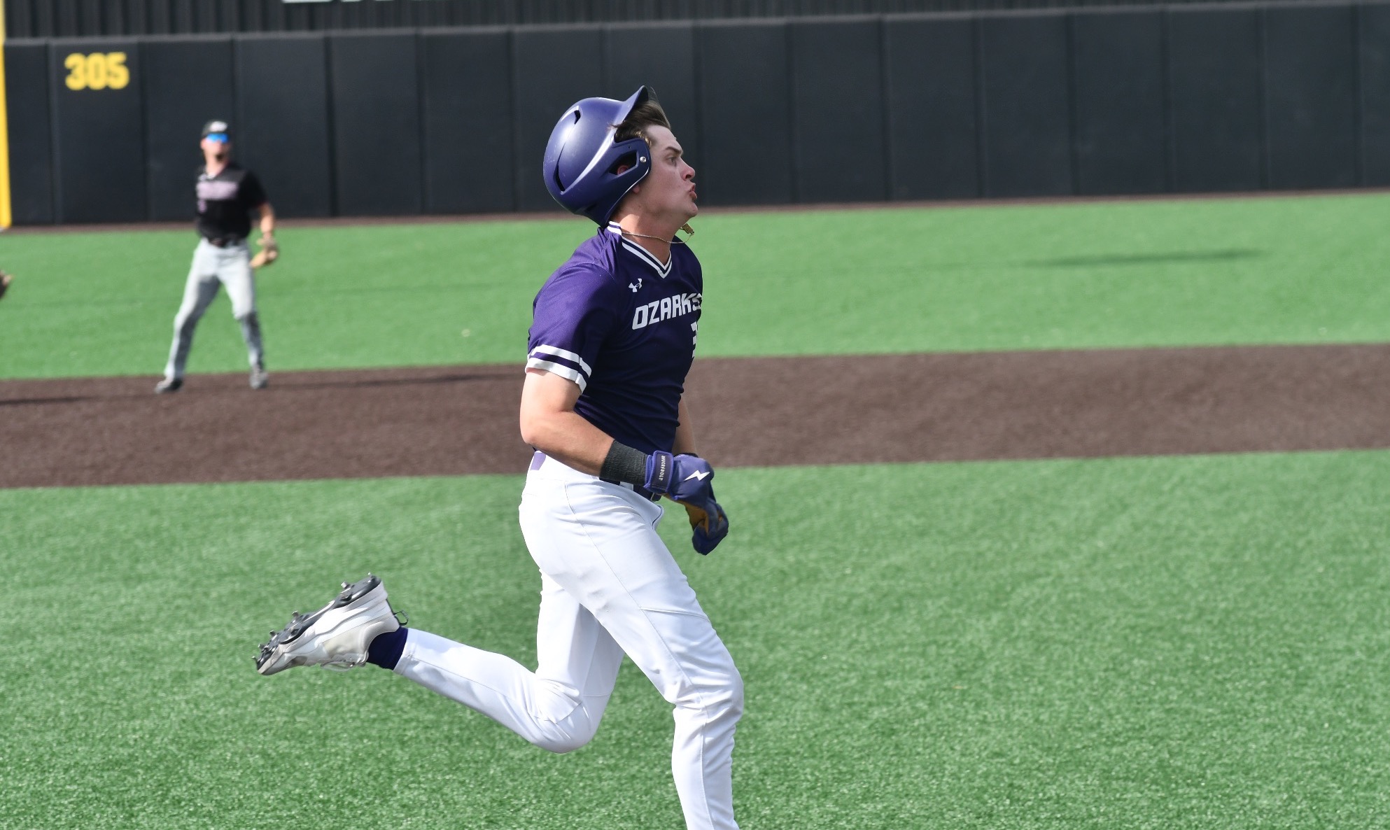 Brett Burks sprints to first base after a hit.